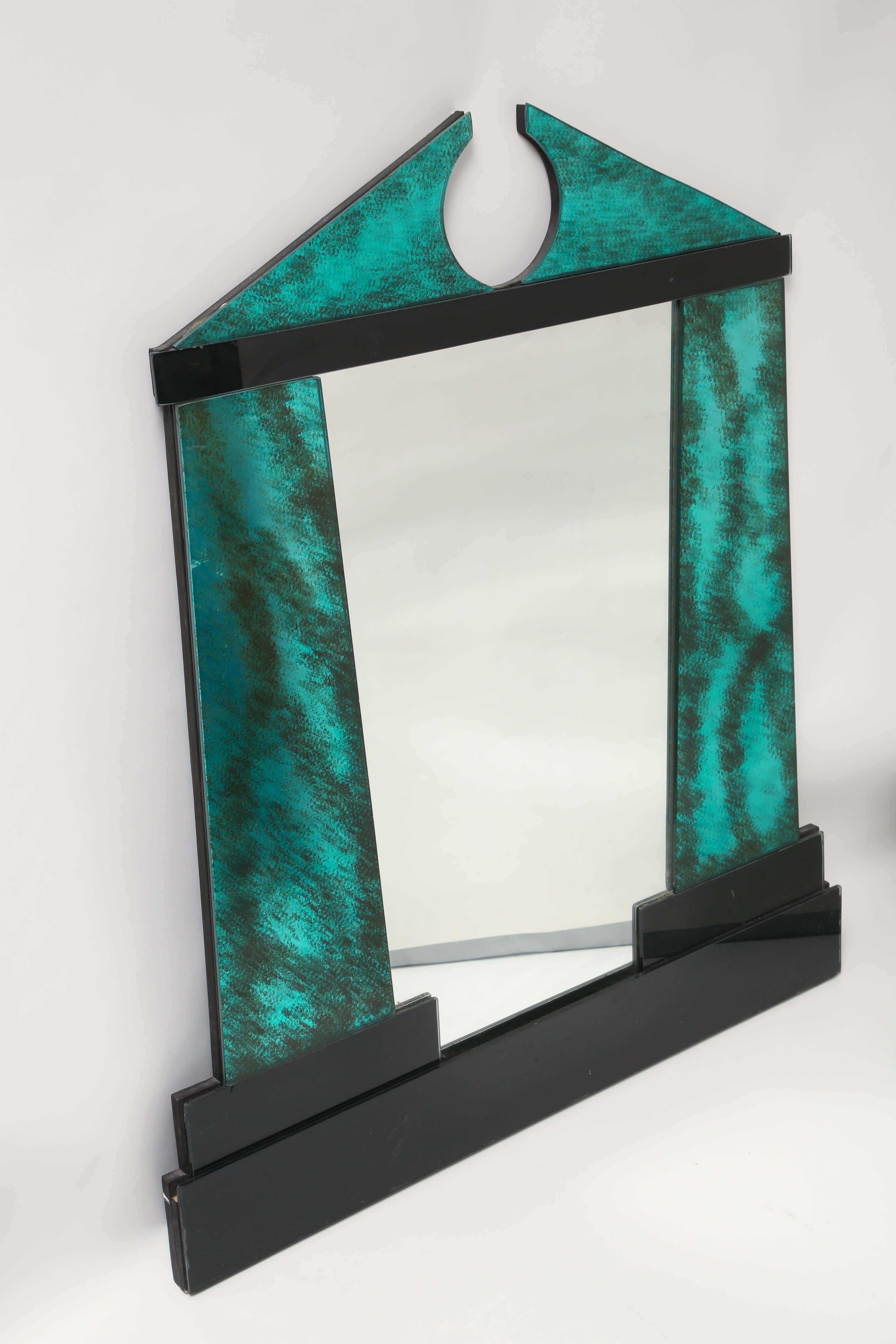 Elegant mirror created by David Marshall in which the glass is hand cut in centuries old tradition of stained glass. The mirror is hand polished and assembled to meet the standards of the sculptors guild. Done in a two-tone combination, faux