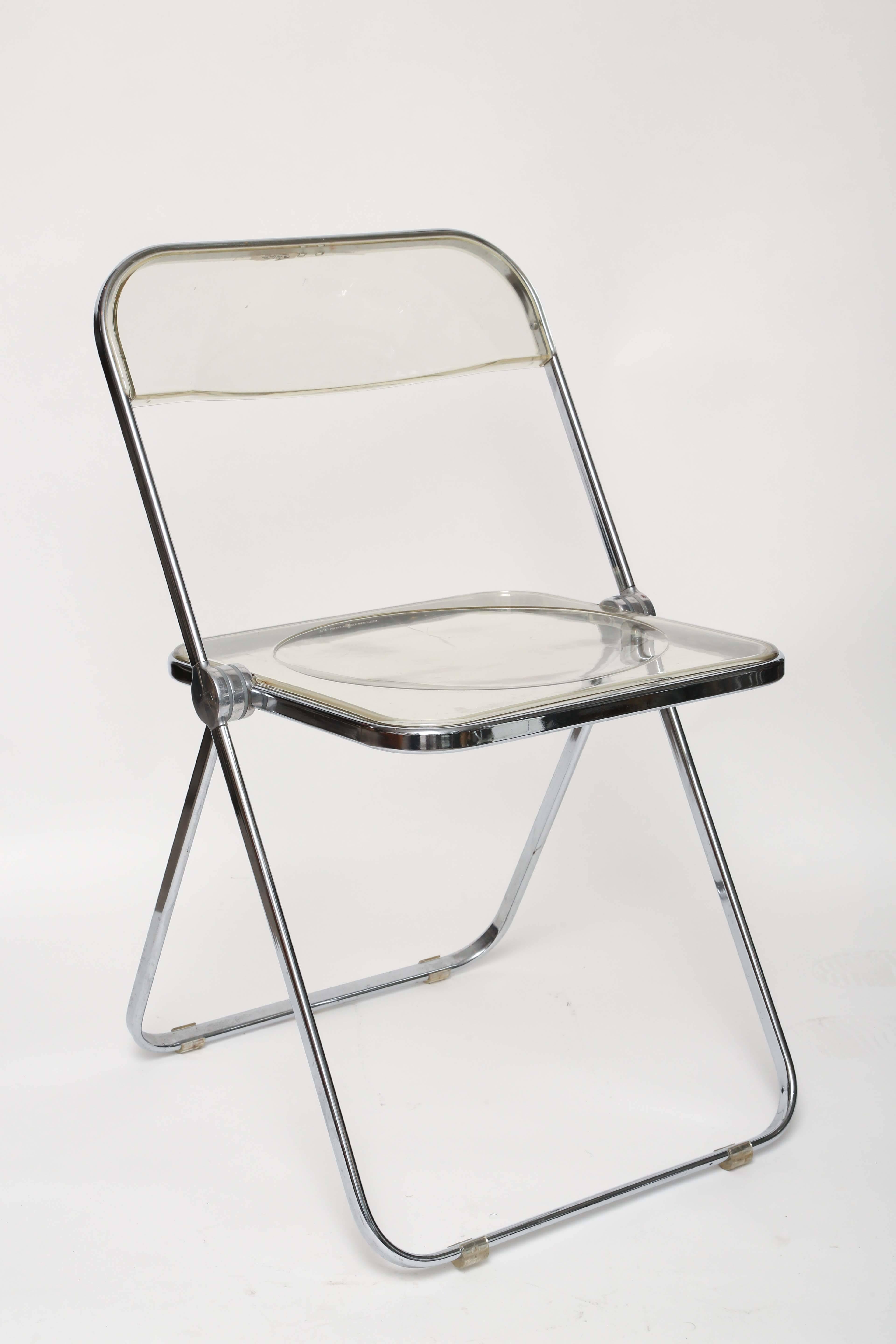 Constructed of metal with chrome fin. And molded acrylic seat and back supports. These chairs are in good all original vintage condition. All chairs have the glides and are signed. These chairs fold to approximate 1