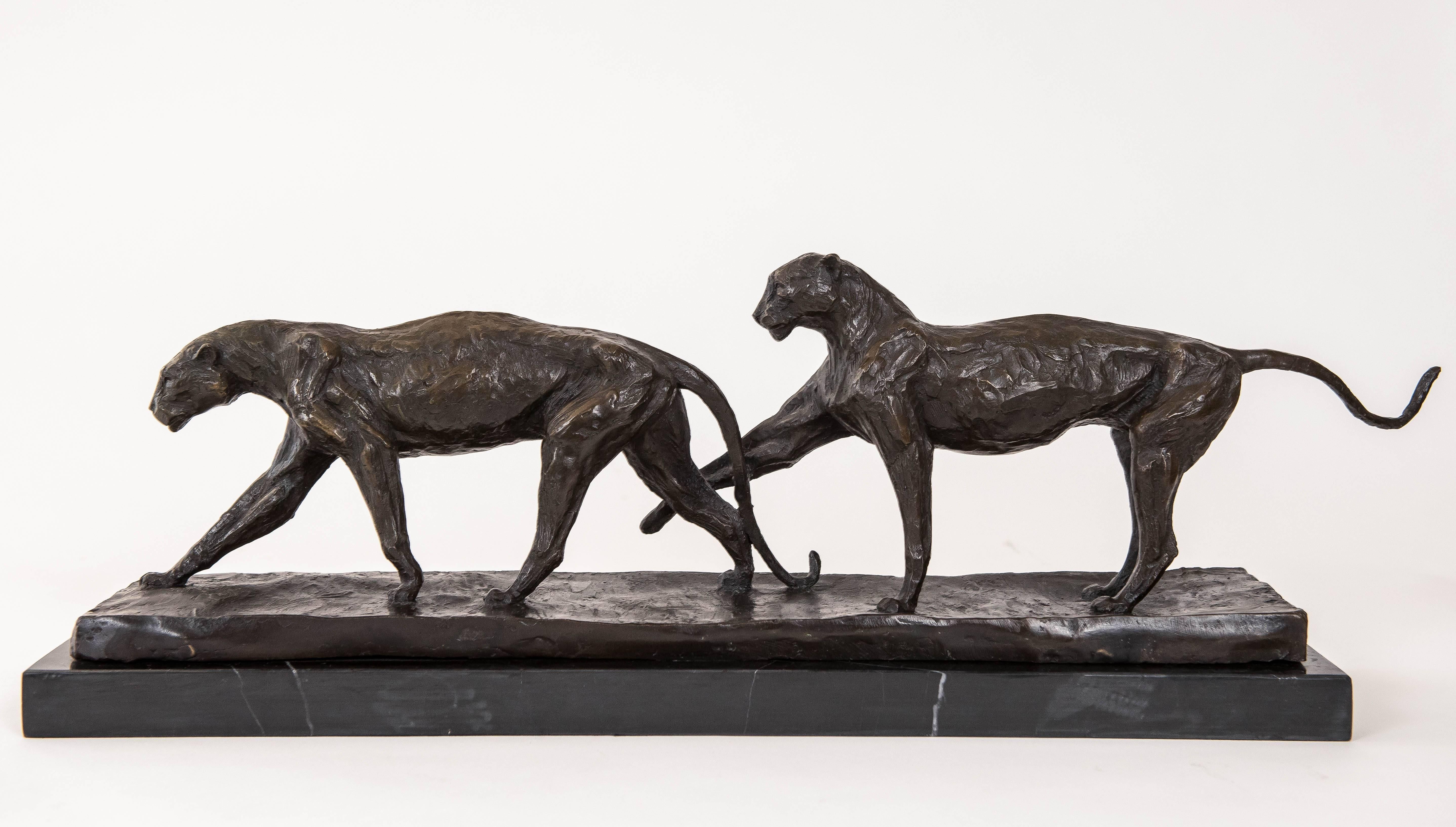 Pair of bronze panthers vigorously detailed. Illegible signature. Mounted on a marble base.