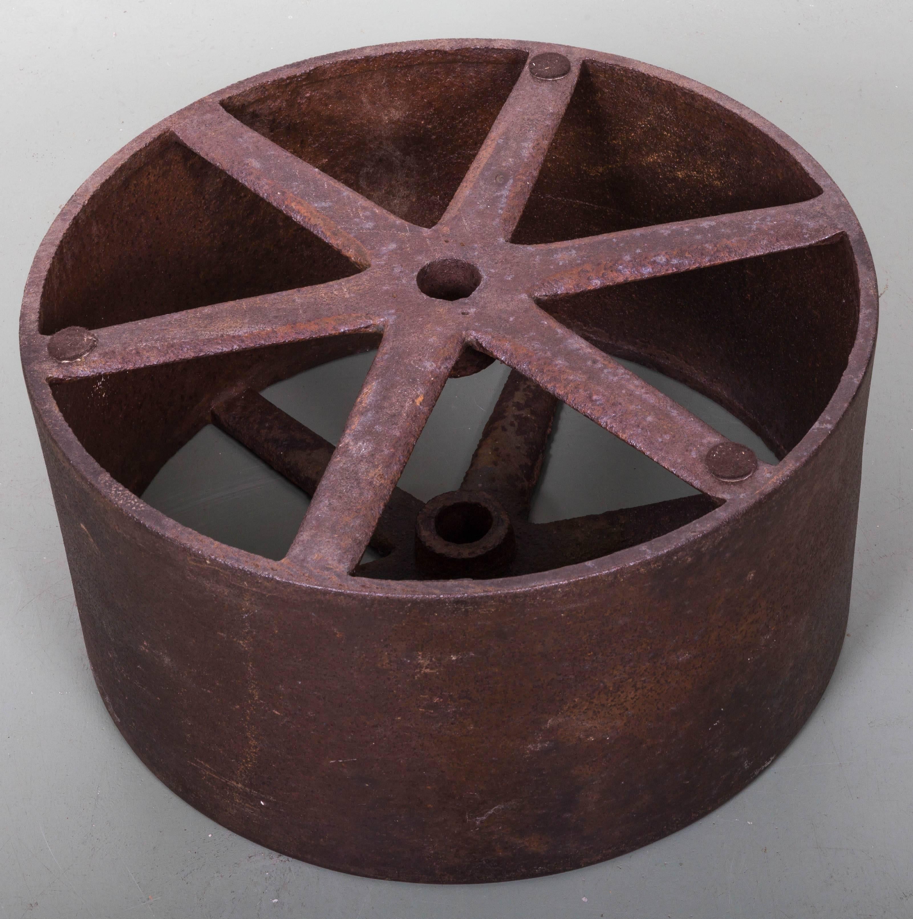 Six triangular shaped spokes radiating from centre axel hole, banded by solid steel. Measurements of wheel 23
