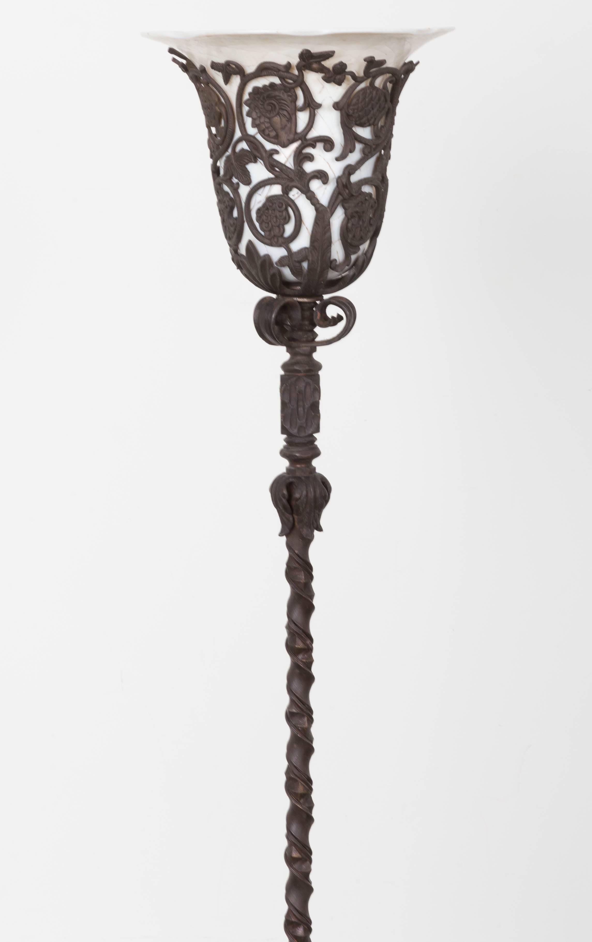 Floor lamp with twisted iron column supporting reticulated floral torchiere with faux marble shades in ivorine glass with craquelure treatment on the angular base.