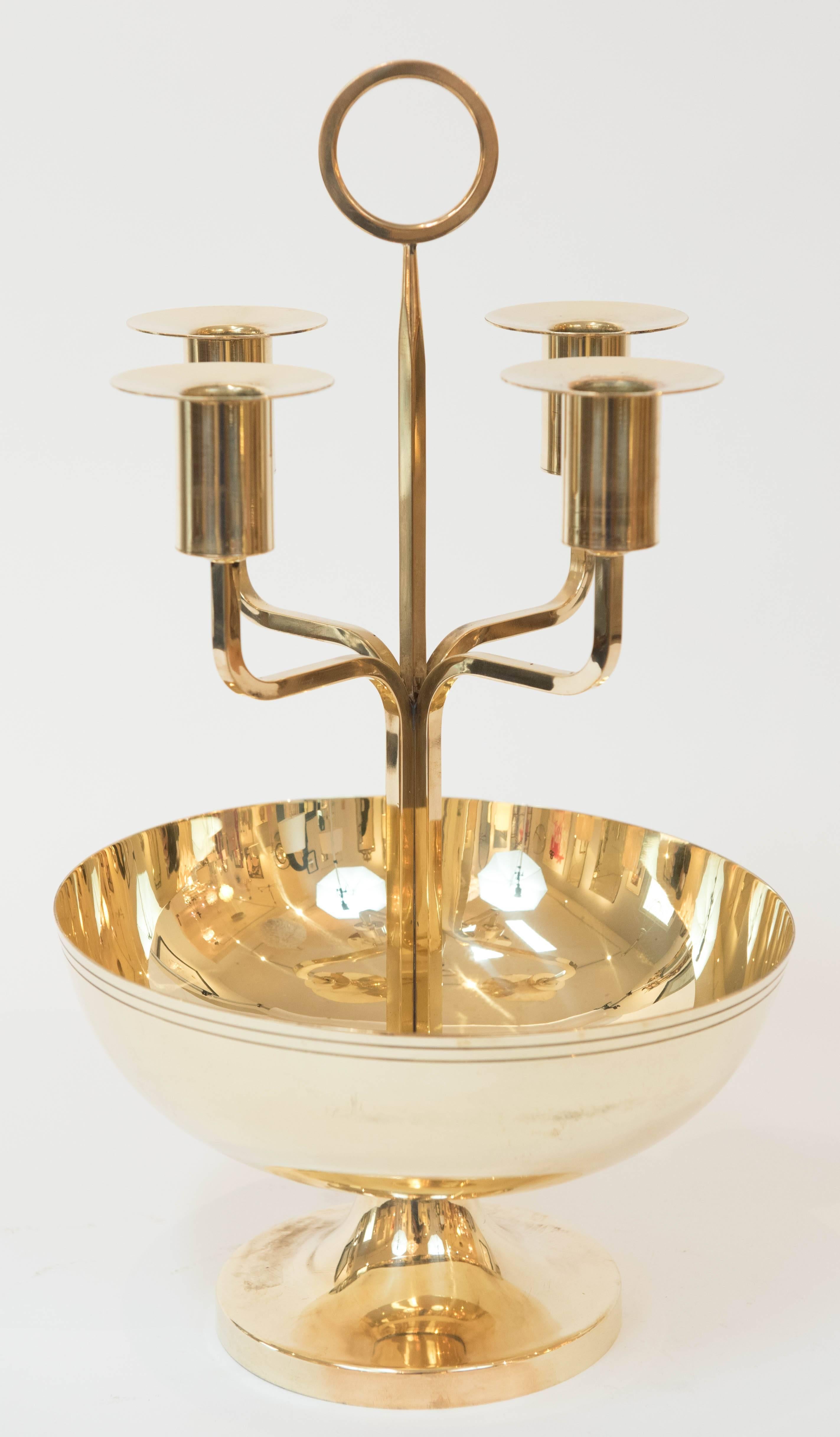 This candelabrum by American
designer Tommi Parzinger has been professionally polished to its natural sheen. It has removable bobeche and is stamped: Made by Dorlyn Silversmiths.