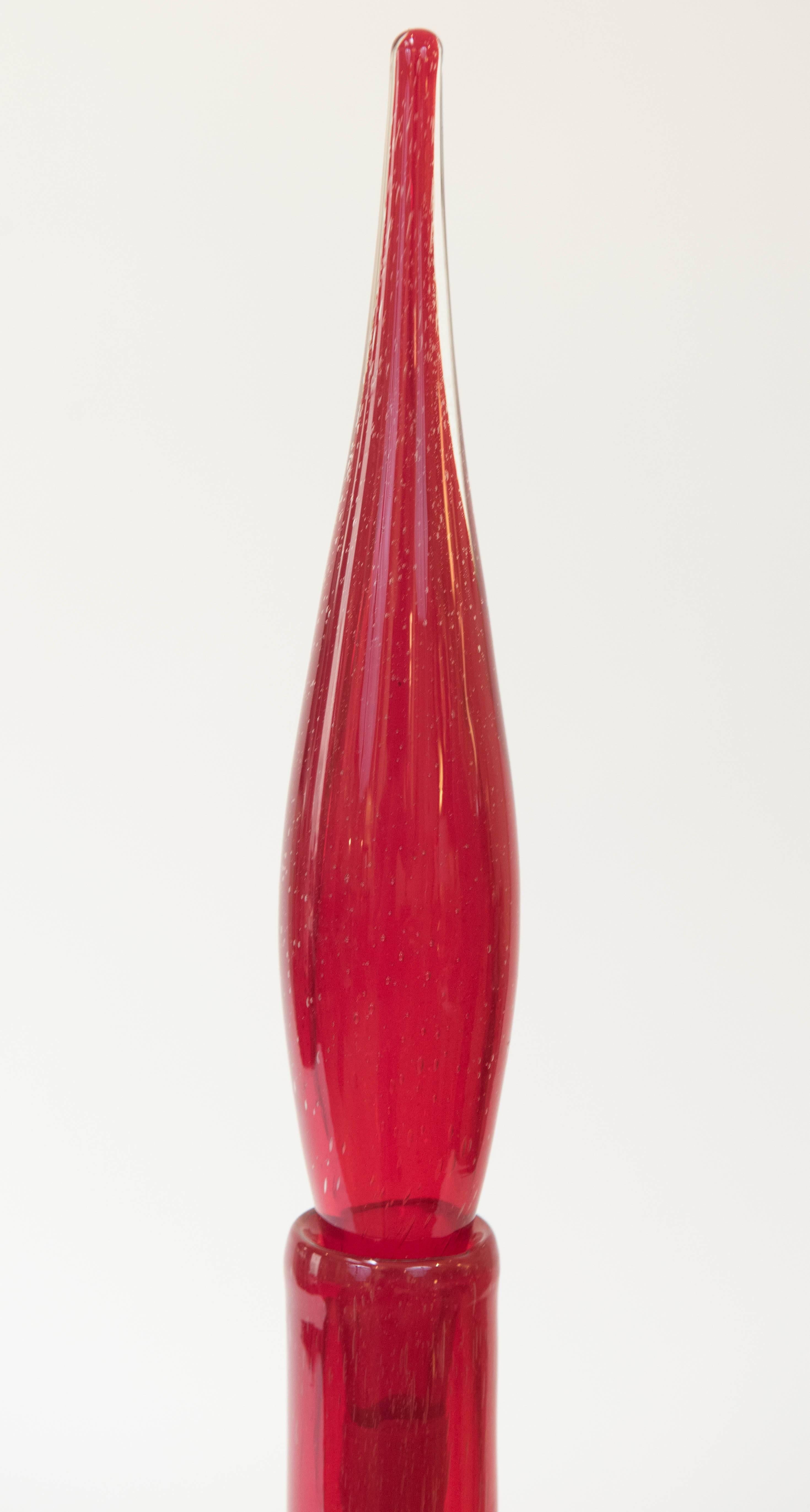 A rare and interesting shaped flaming red glass decanter with an elongated stopper.