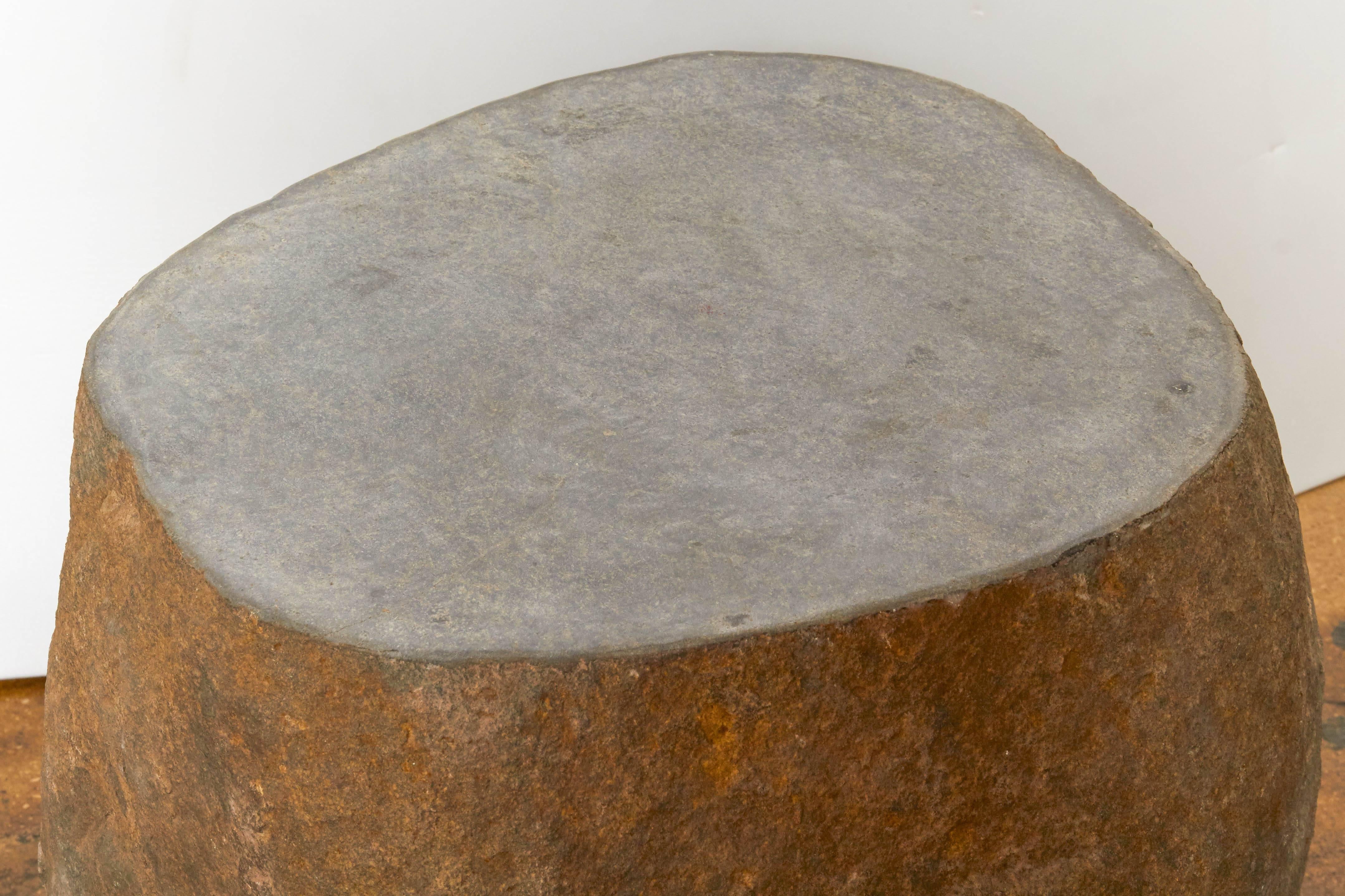 A solid stone end or side table or stand with a polished top.