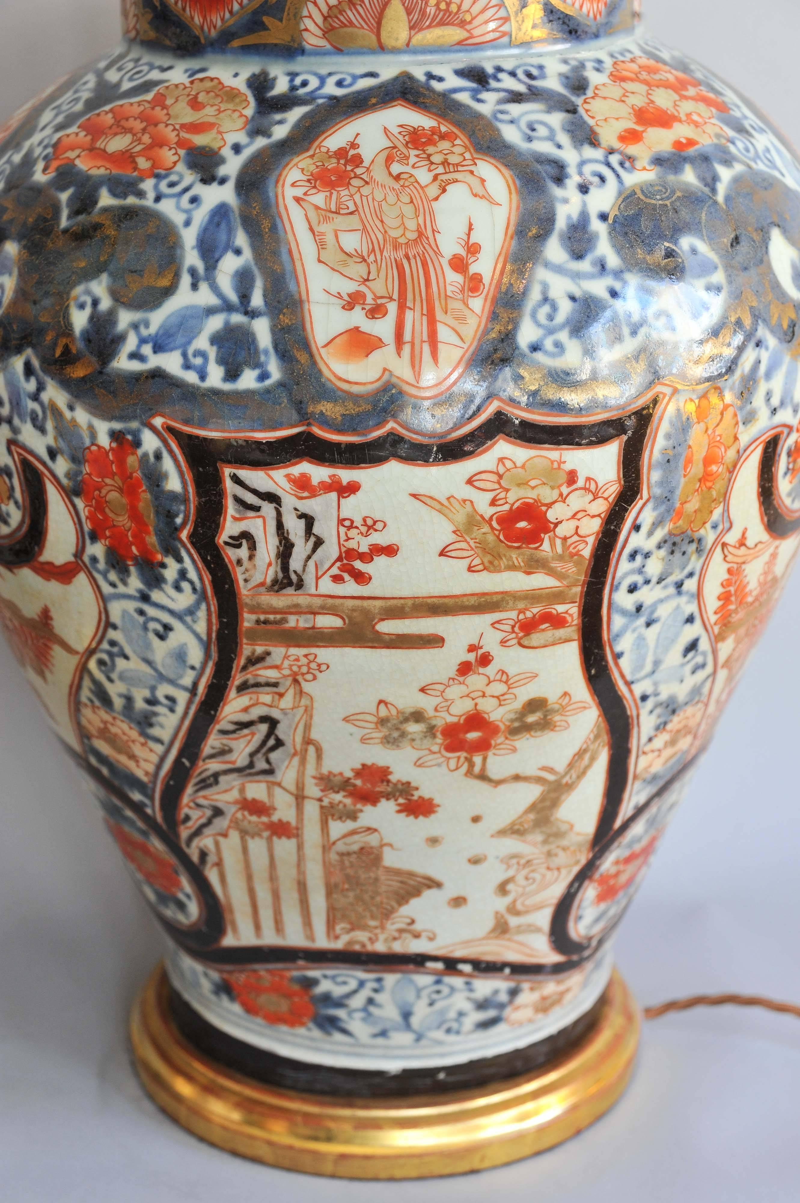 A Fine Pair of Early 18th Century Lamped Imari Vases on Gilt Bases 1