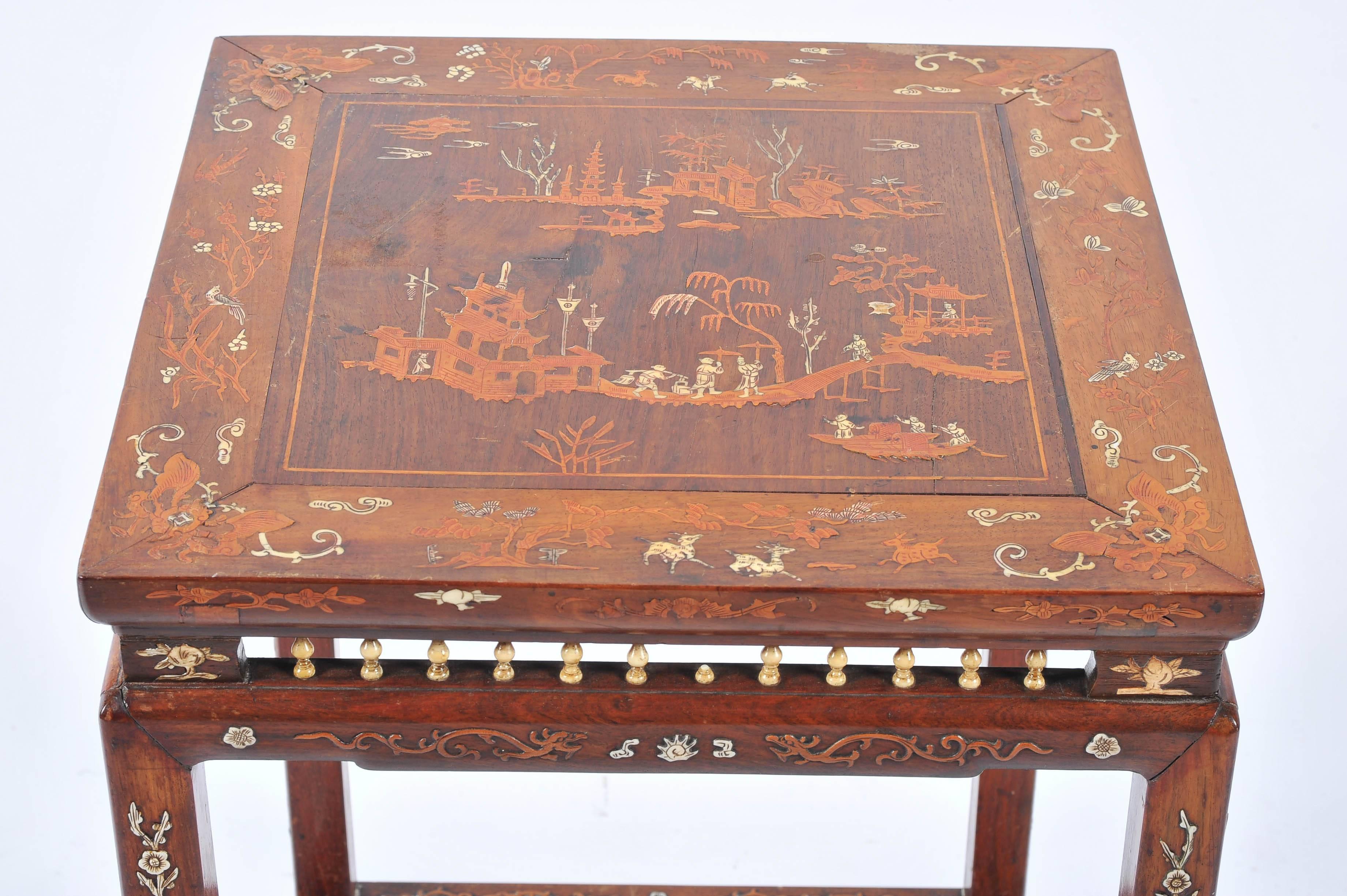 A good quality 19th century Chinese hardwood inlaid side table, depicting classical oriental scenes and motifs.