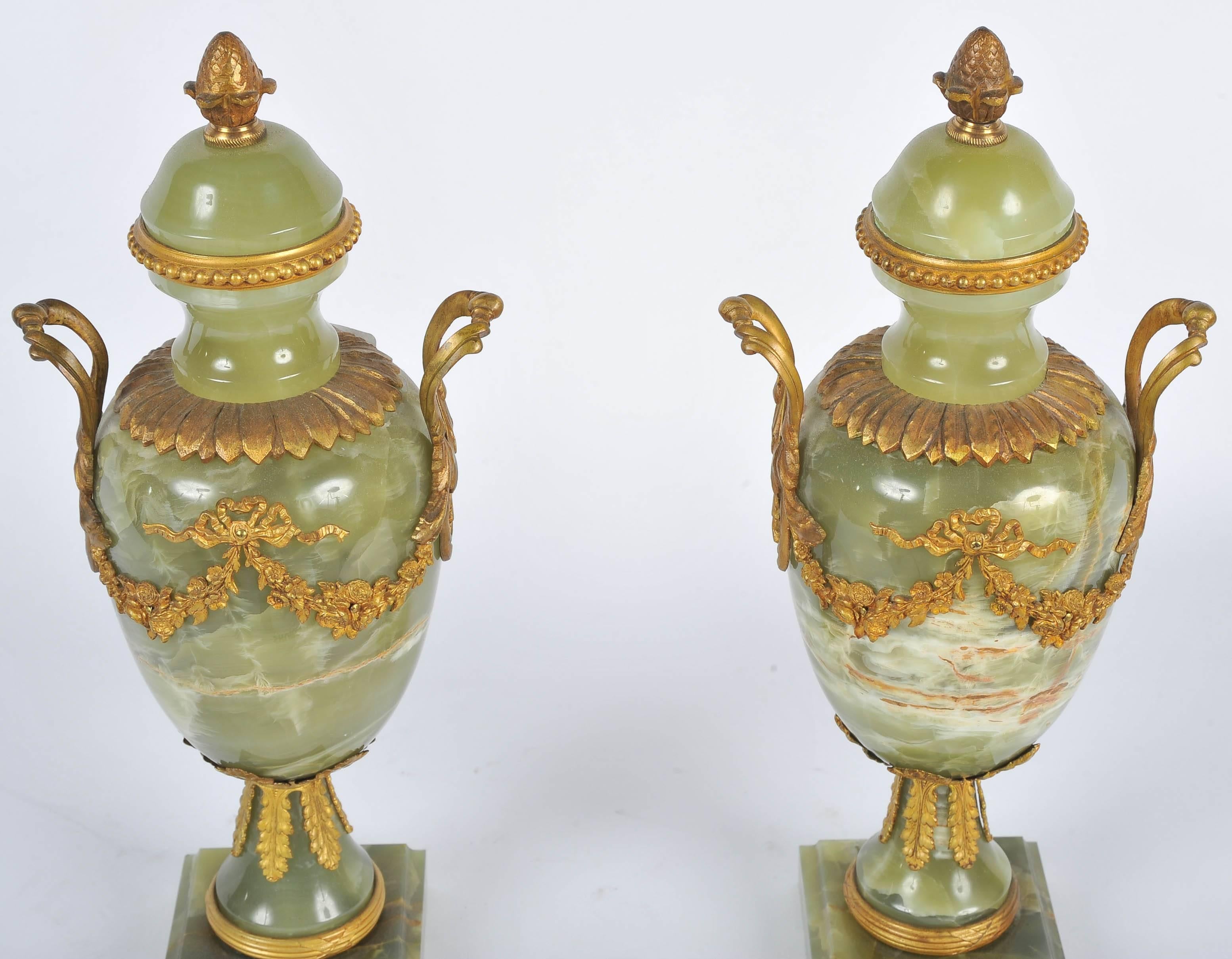 A good quality pair of late 19th century onyx and gilded ormolu lidded vases.
  