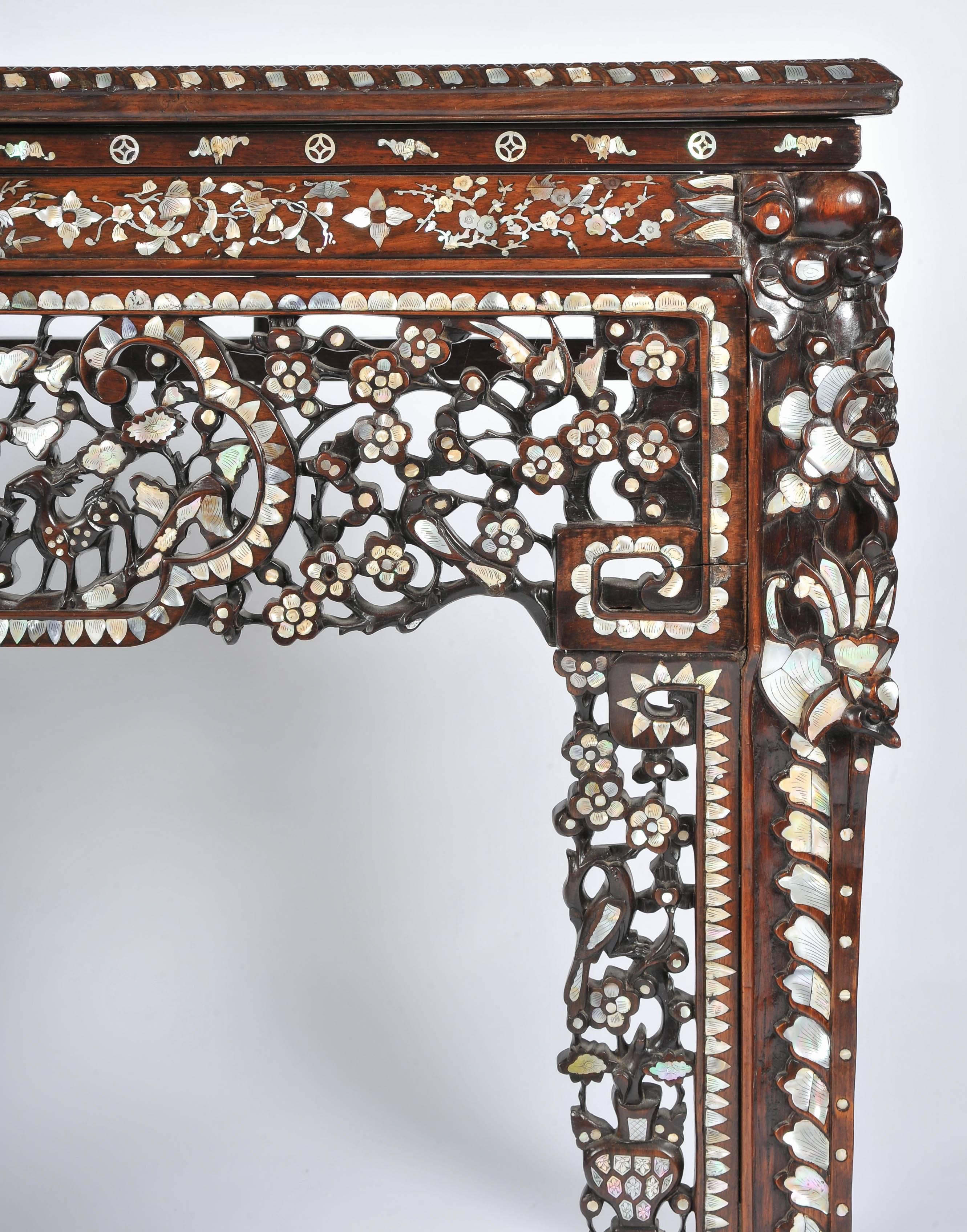 A very impressive 19th century Chinese hardwood alter table, having three inset marble panels to the top, wonderful carved decoration to the frieze and legs. The whole table having fine mother-of-pearl inlay.