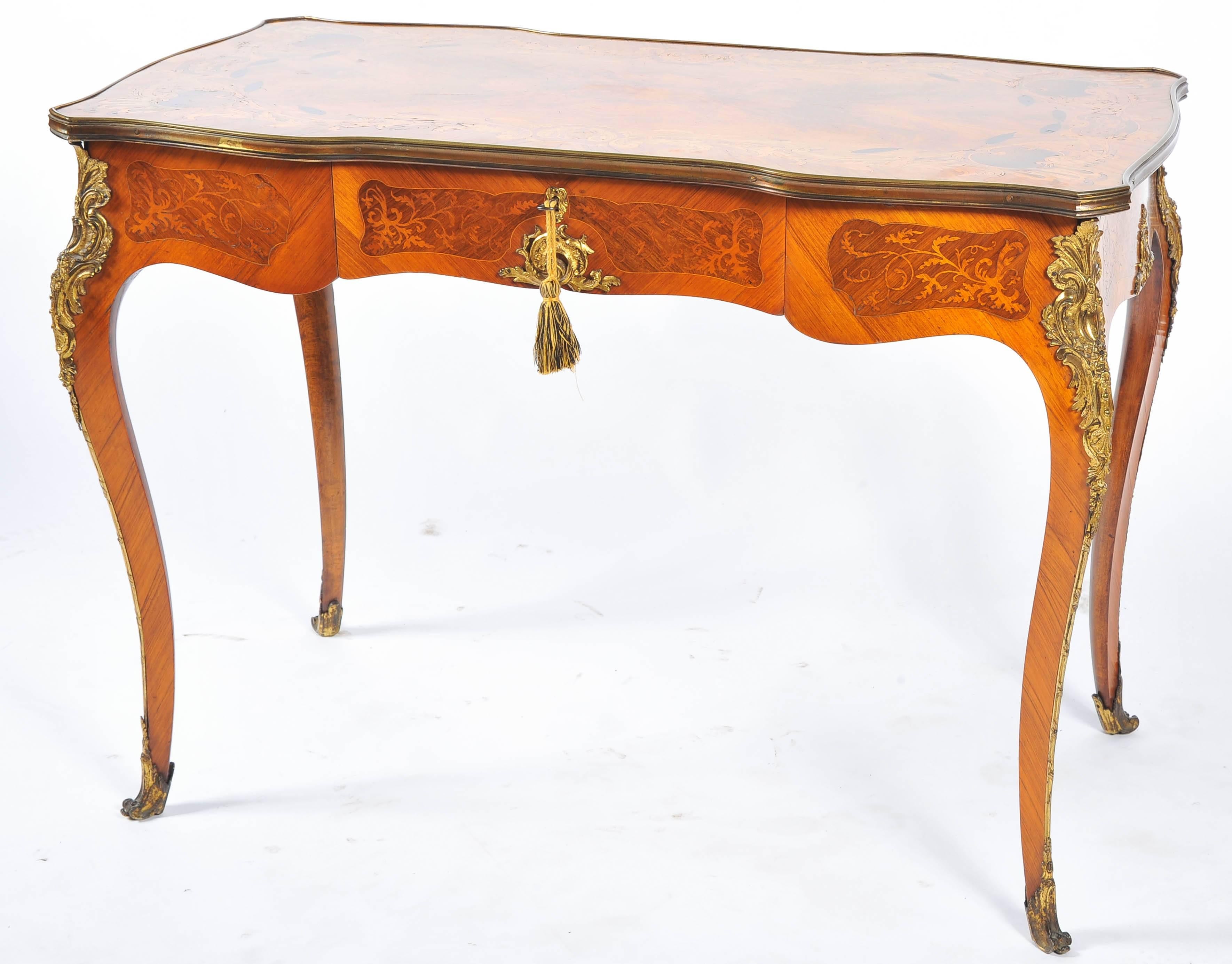 A very good quality French marquetry side table, having inlaid swag and foliate decoration, a single frieze drawer. Ormolu mounts and raised on cabriole legs.