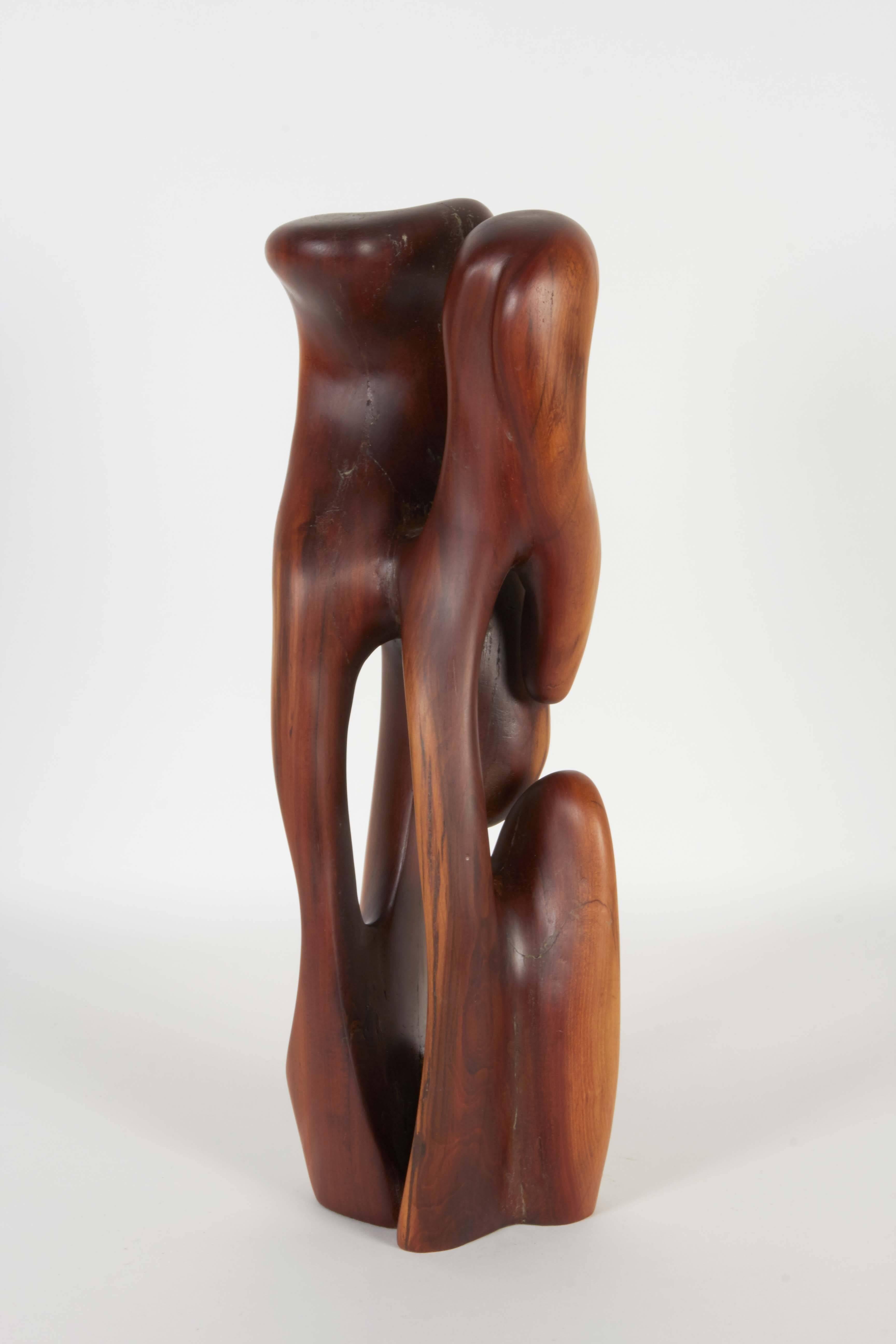 A modern abstract sculpture by an unknown artist, crafted of wood, carved and smoothed into a highly organic shape. The sculpture remains in very good condition, with presence of repairs to cracks, consistent with age.