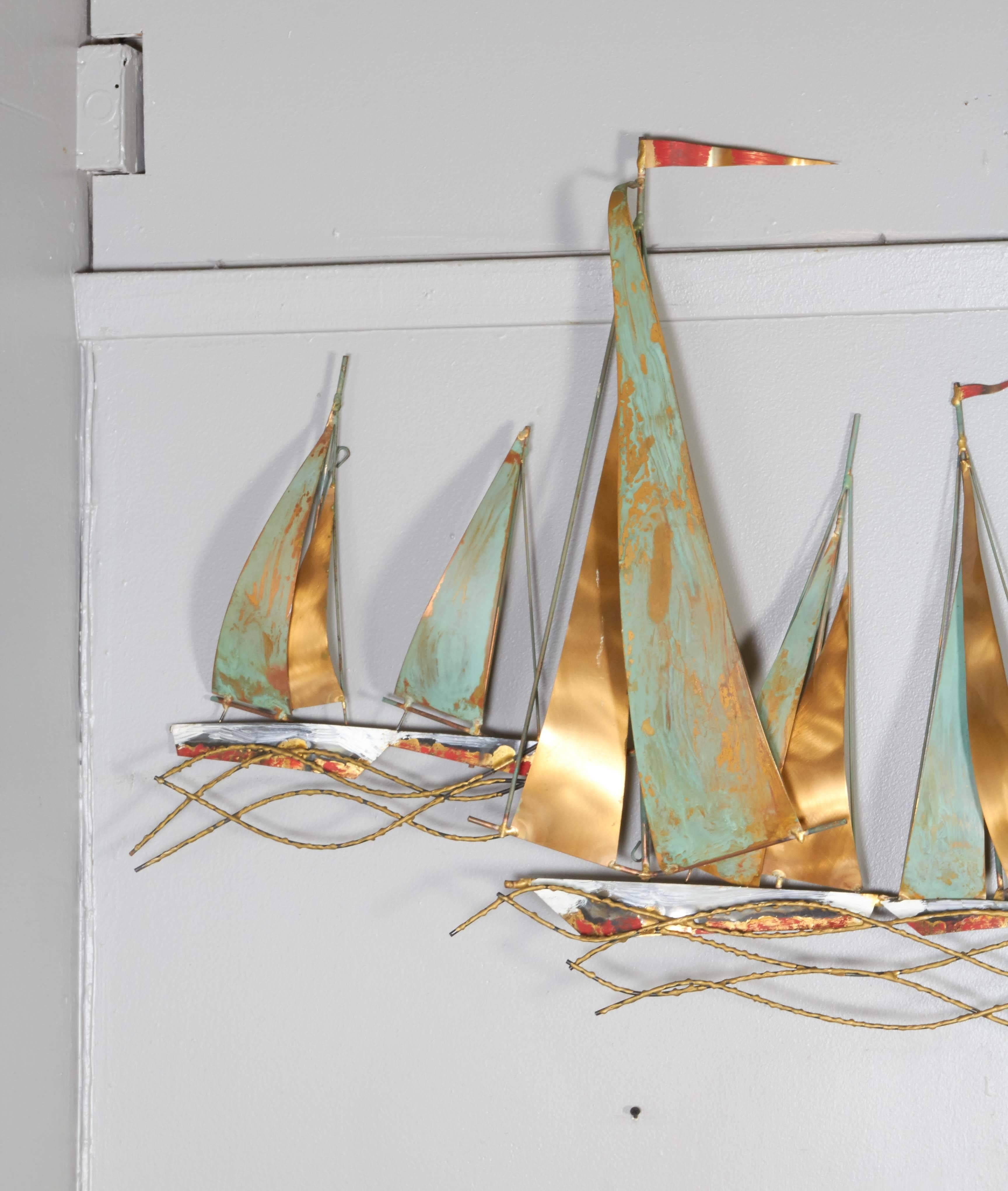 A wall-mounted Curtis Jere sculpture, comprised of soldered and reworked mixed metals, which form sailboats on rippling waves, detailed with verdigris patina and enamel. Markings include signature and date [© C. Jere '68] on the far right boat. This