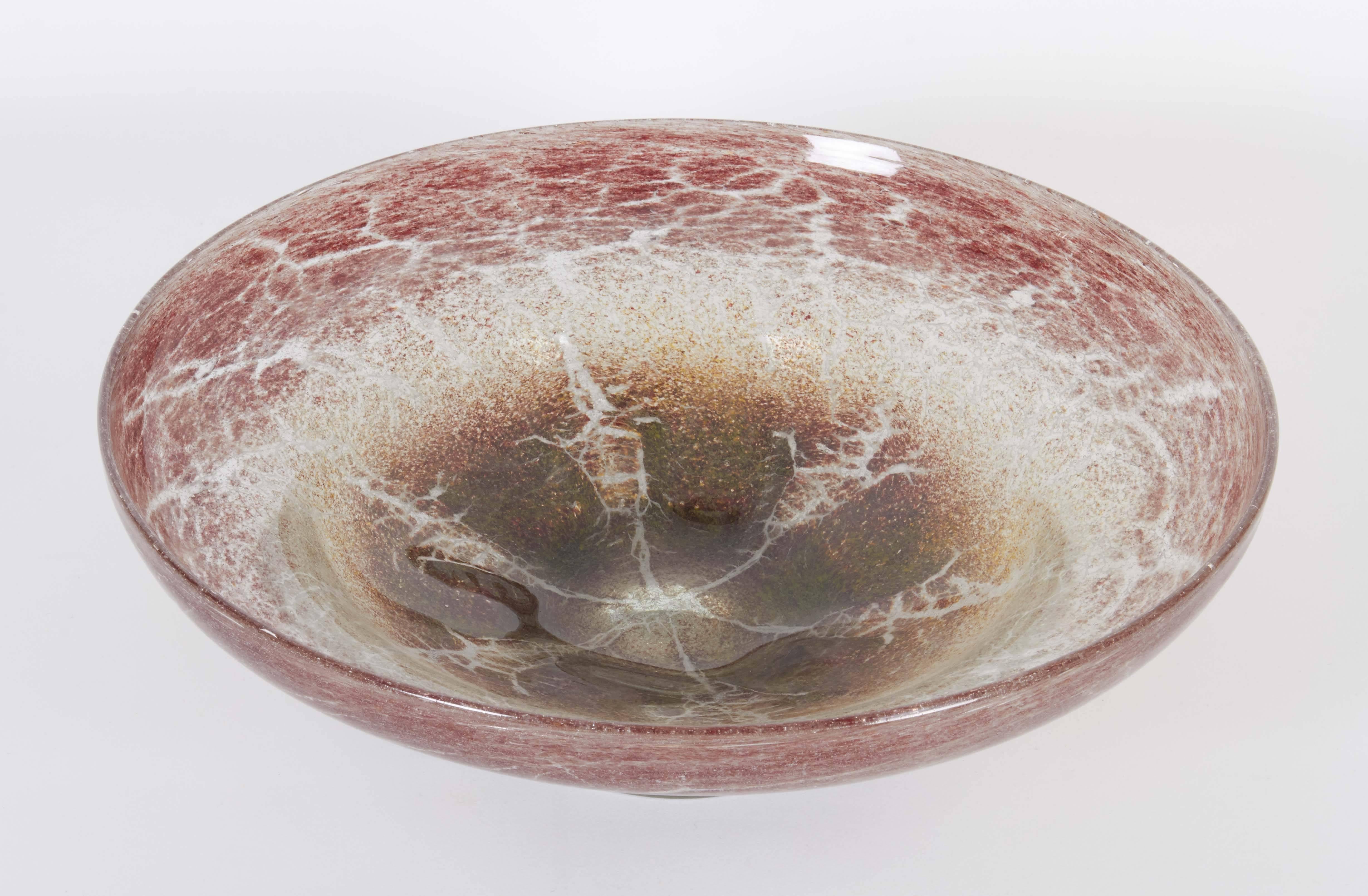 A large decorative 'Ikora' glass bowl, produced, circa 1930s-1950s by WMF (Württembergische Metallwarenfabrik) in Germany, with crackled details in earthy and red tones, raised on a single foot. Very good vintage condition, consistent with age and