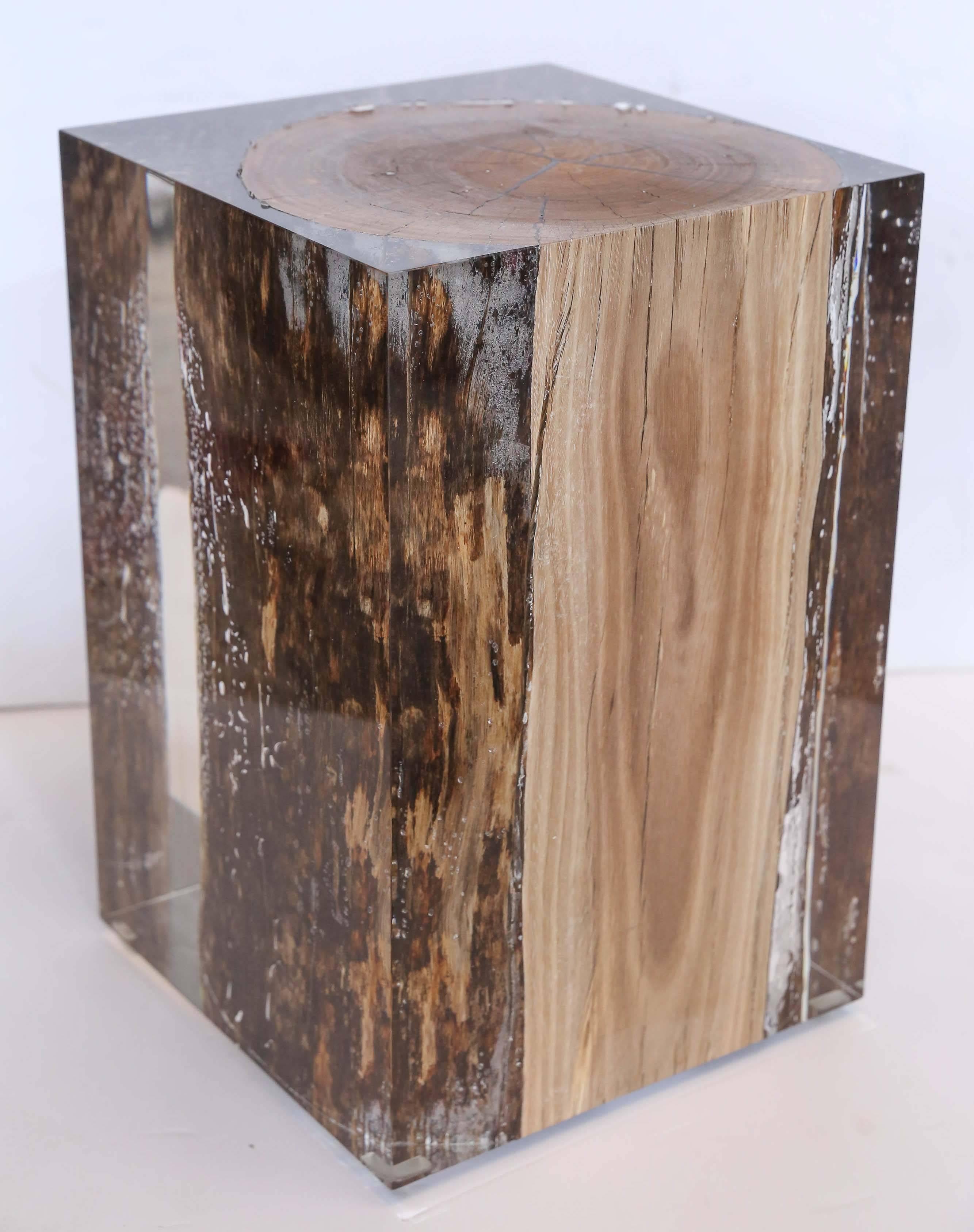 Handcrafted acrylic glass embedded with a driftwood trunk that is sized either as a side table or seating as a stool or ottoman. Cut, sanded and hand polished to a perfect transparency. Consider it a work of art that you can also sit on and includes