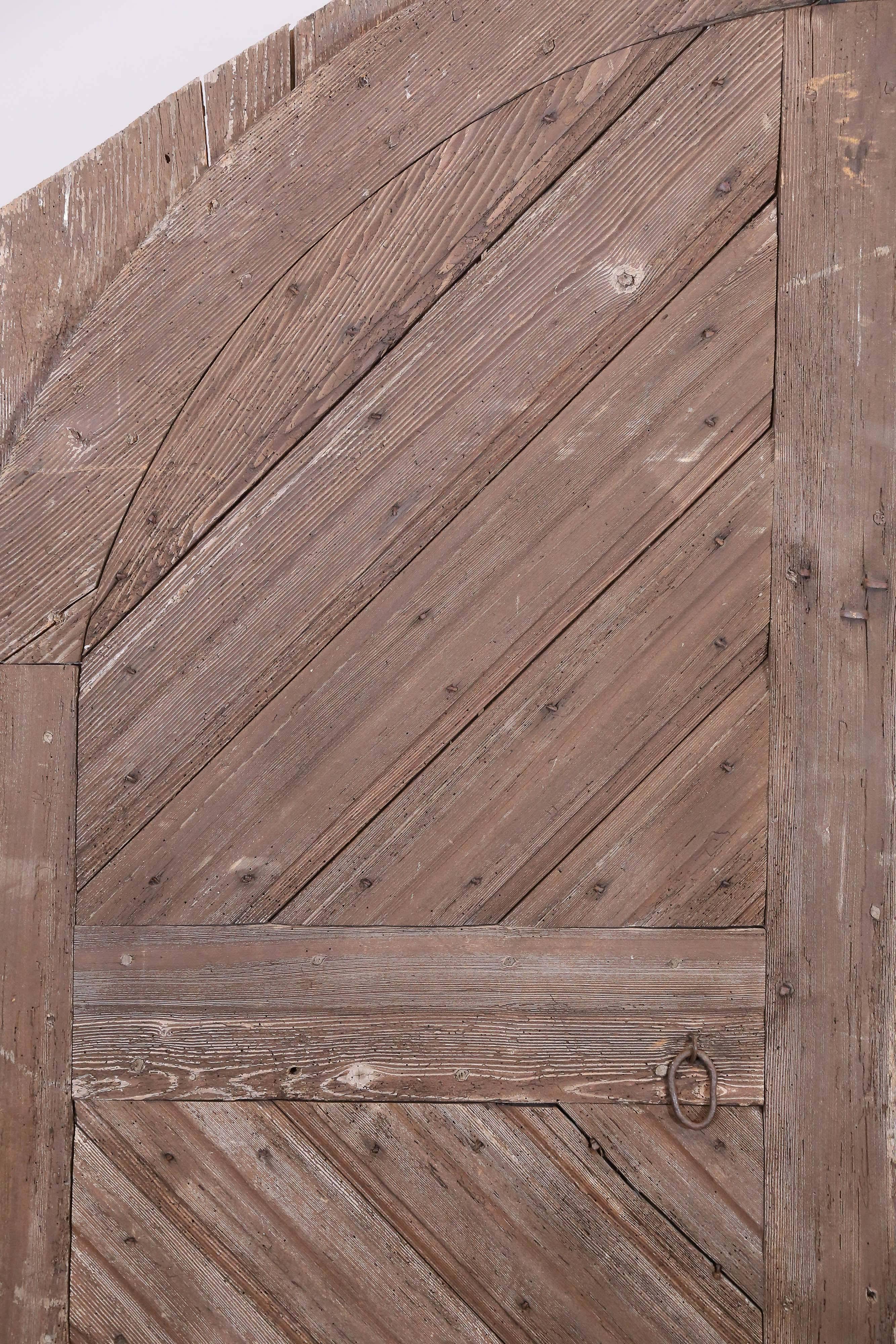 Truly an exceptional pair of barn doors found in Chartres, in Northern France, this pairing is crafted out of pine and date to approximately 1800. Includes iron hardware and measures 78" in height, 67" width for both doors at the centre
