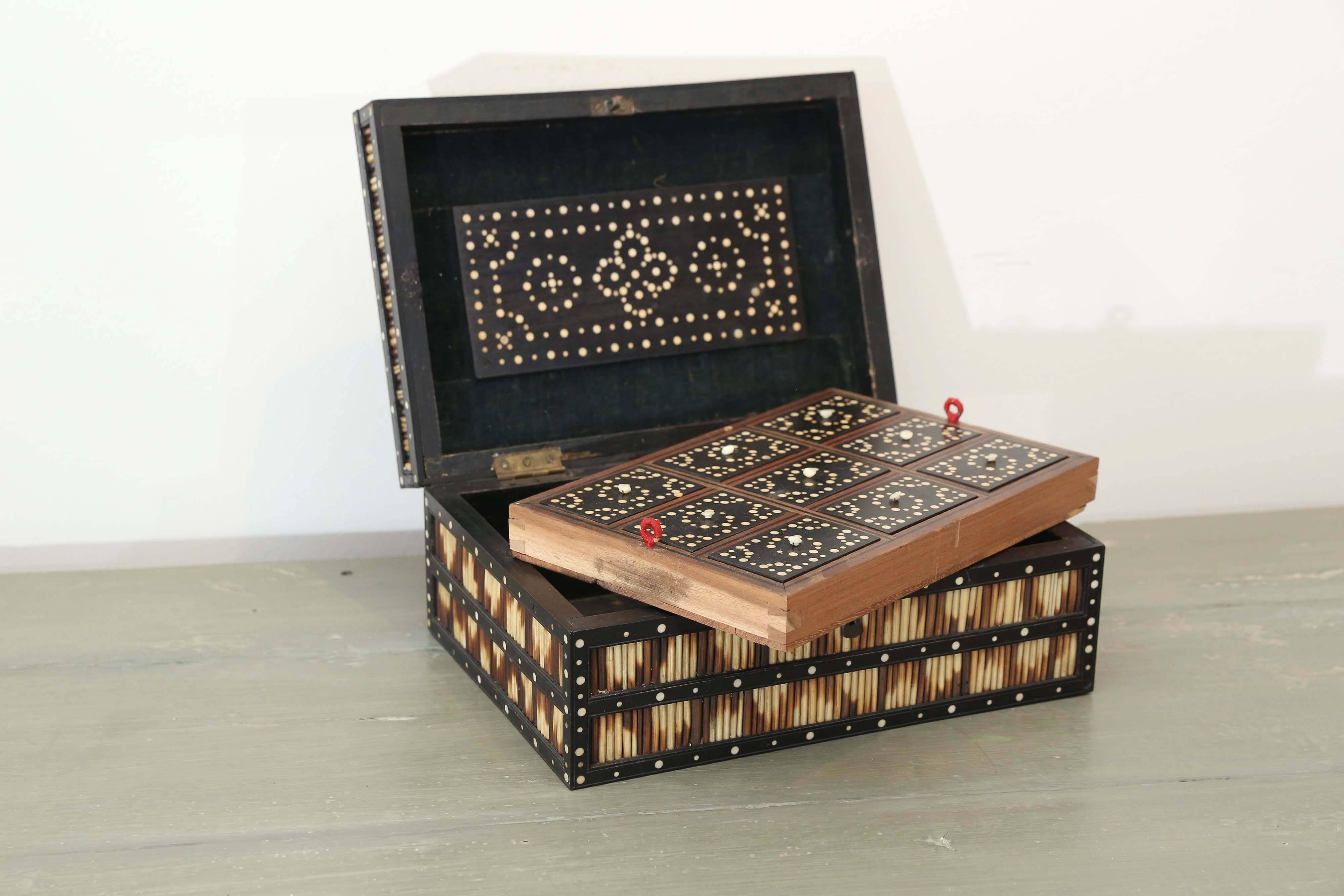 19th century Porcupine quill box with an inset tray with nine individual compartments. Note the design created by the specific placement of the colored quills. A few of the bone circular details are missing. These quill boxes were made in India for