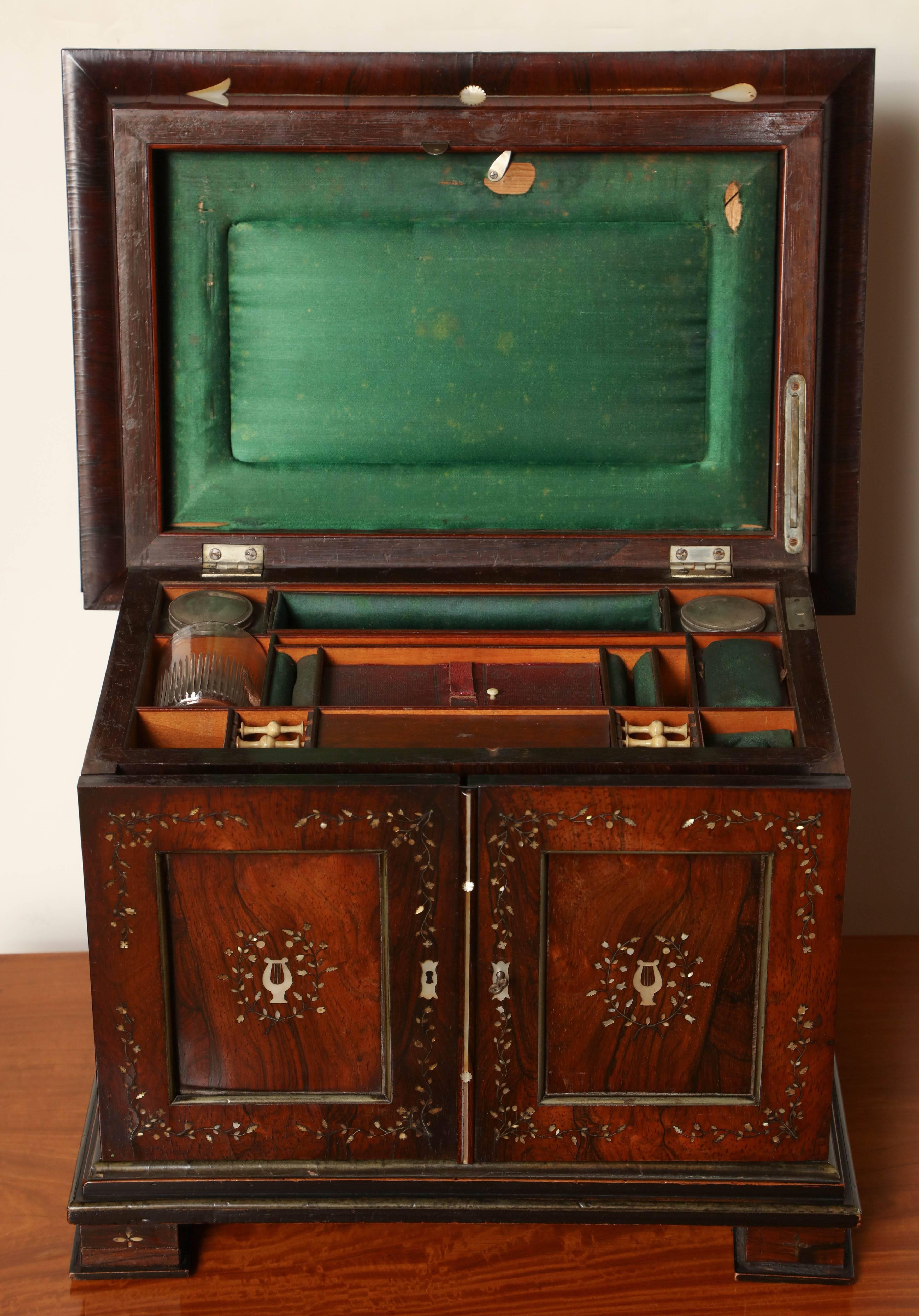 19th century hardwood and mother-of-pearl inlaid necessaire.
With a top hinged lid, two doors and three working drawers.