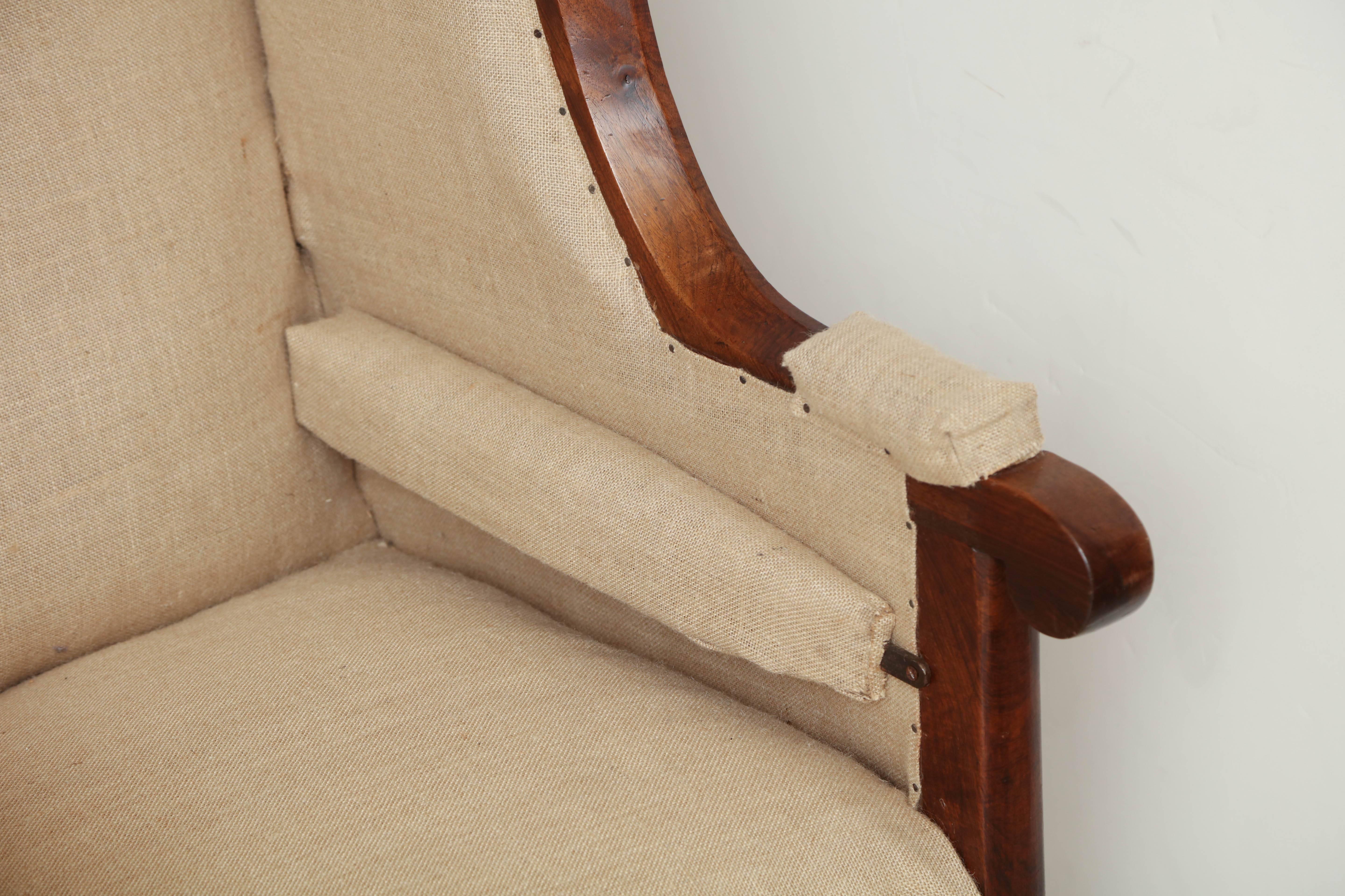 Early 19th Century French Walnut Upholstered Wing Chair For Sale 1