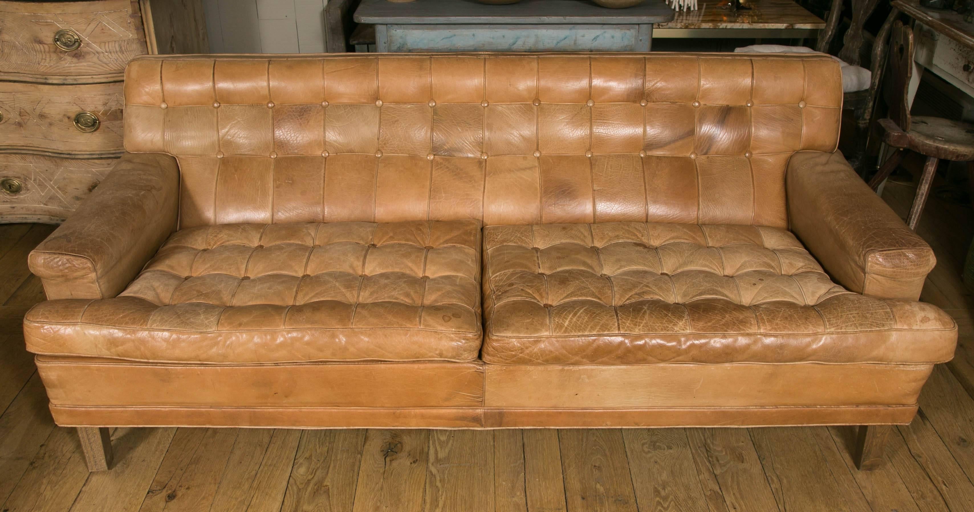 Sofa model Mexico designed by the Swedish designer Arne Norell and produced by Arne Norell AB in Aneby, Sweden.
Natural buffalo leather in light cognac color with nice clear patina. Some traces are due to vintage use.
One sofa is higher than the