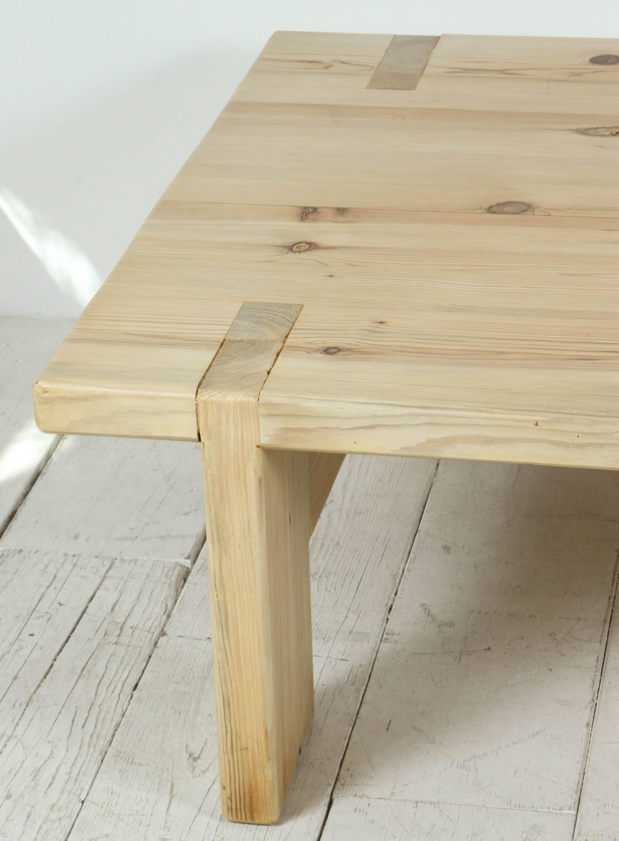 Tall light wood pint coffee table with top detail.