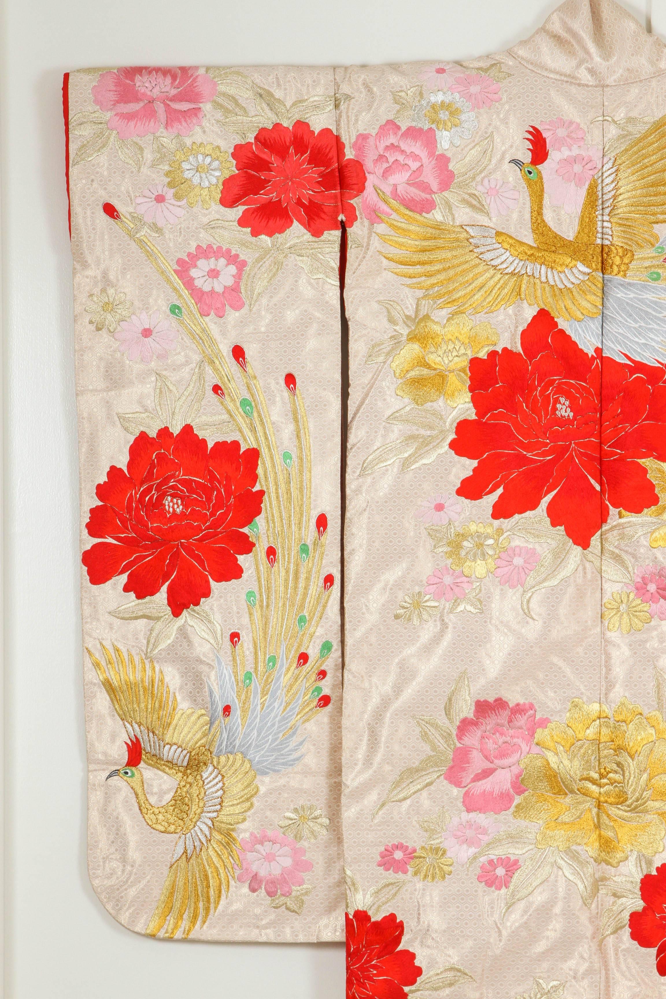 A vintage Mid-Century ivory color silk brocade collectable Japanese ceremonial kimono. One of a kind hand crafted.
Fabulous museum quality ceremonial piece in pure silk with intricate detailed hand-embroidery throughout accented with floral gold