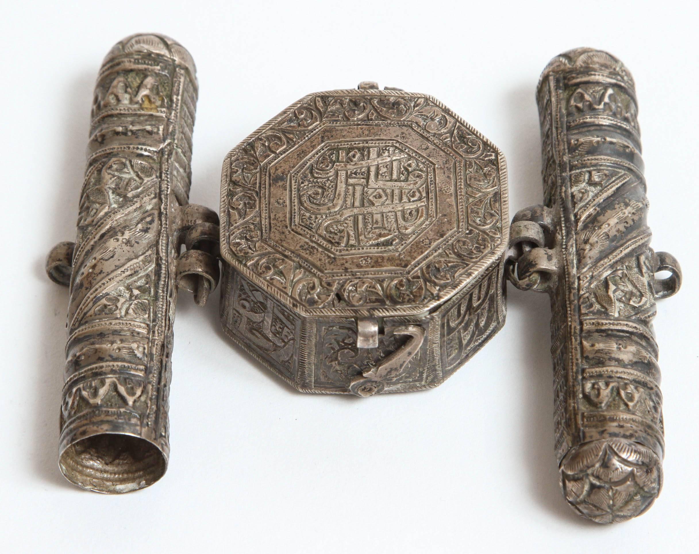19th century three part, silver repousse, octagonal talisman miniature Koran case which would have stored select verses of the Koran Revelation considered to hold special protective powers.
A latch at the bottom opens the hinged box. 
Decorated