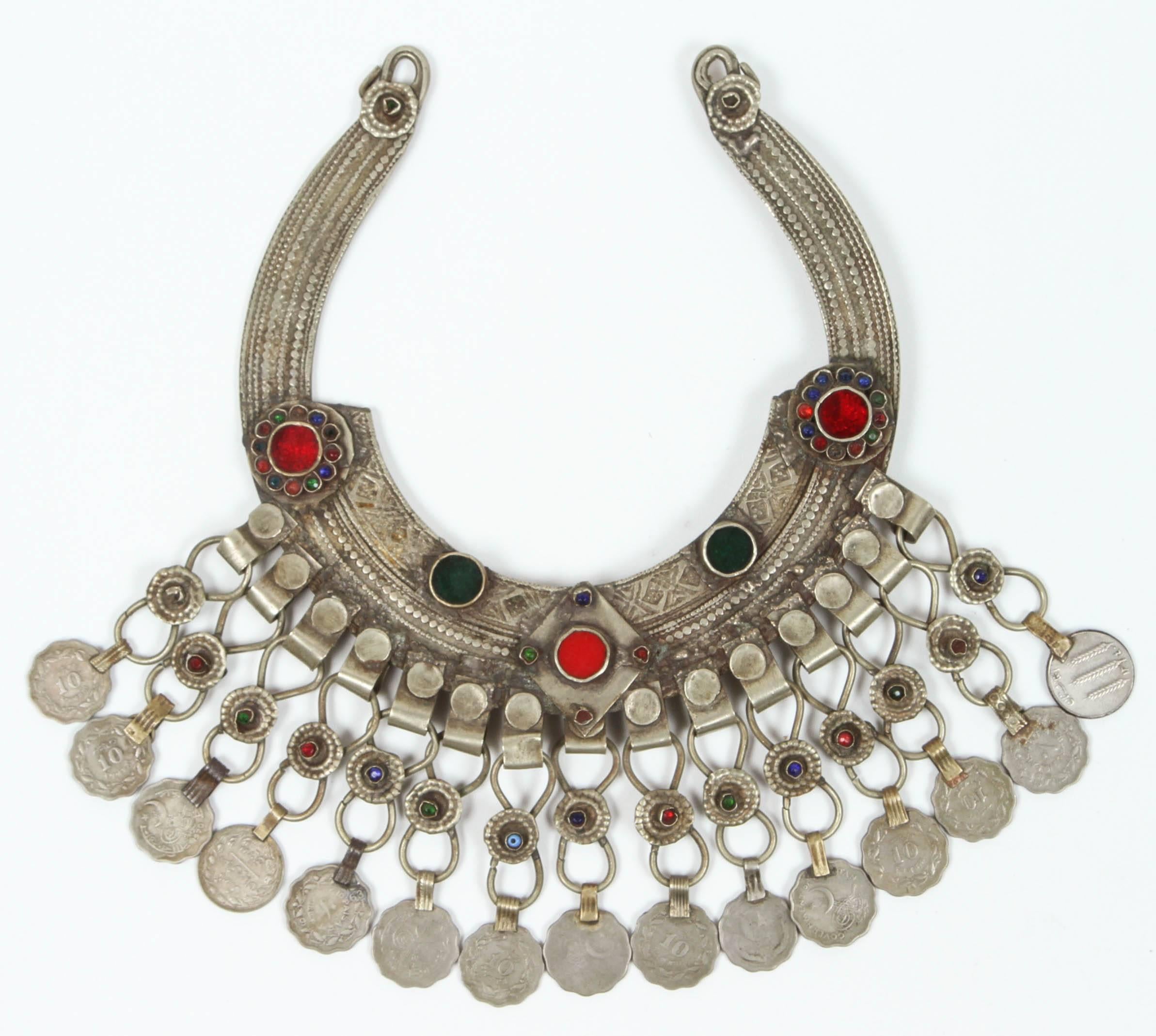 A Moroccan Tribal jewelry vintage set of a bracelet and a chocker inlaid with colorful glass beads in red and green and dangling coins. Silver, but not of the standard of sterling and richly embellished with applied silver designs and filigree.