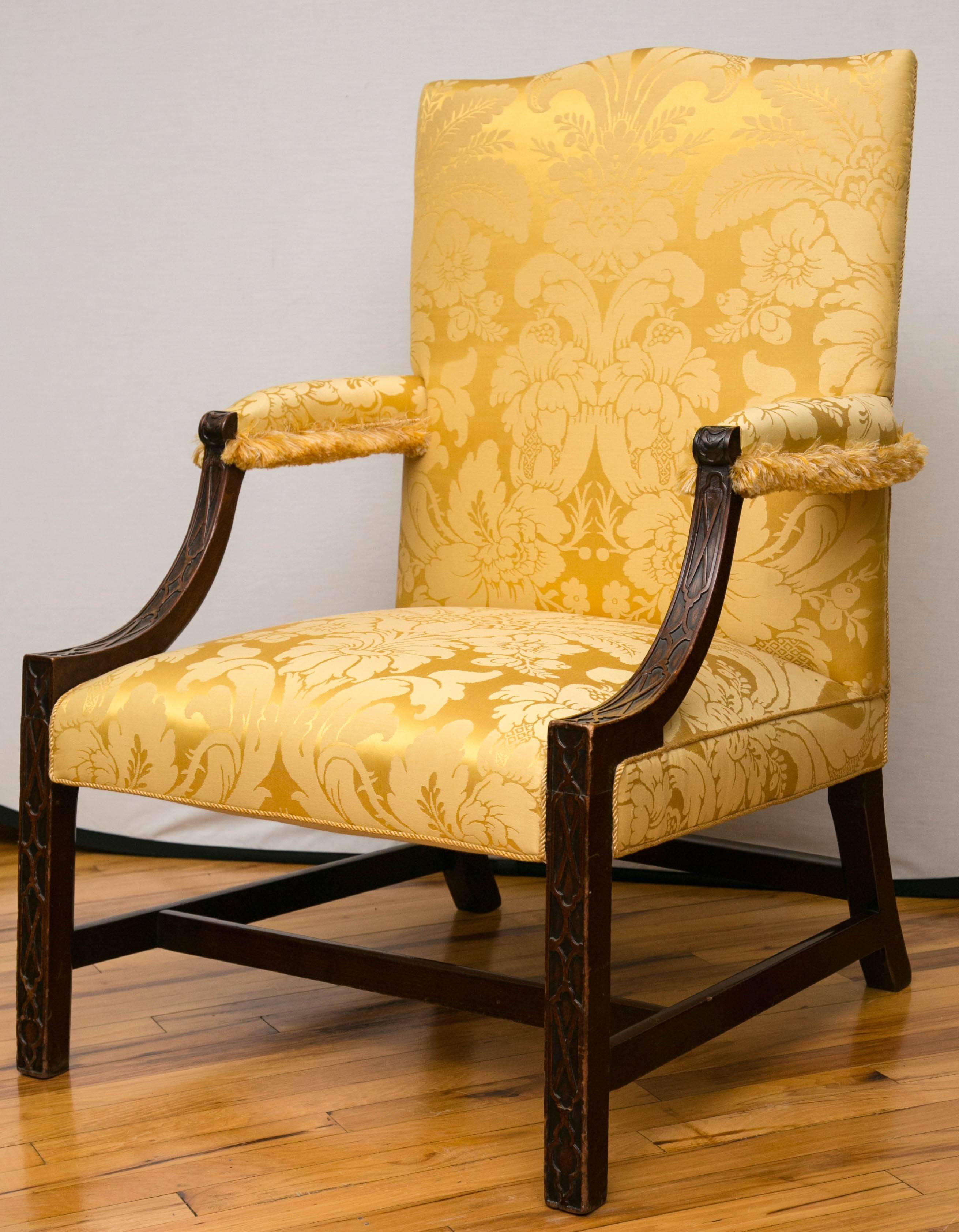 A mid-18th century George III period mahogany Gainsborough armchair, having set back filigree design arms supported on square legs with stretchers.