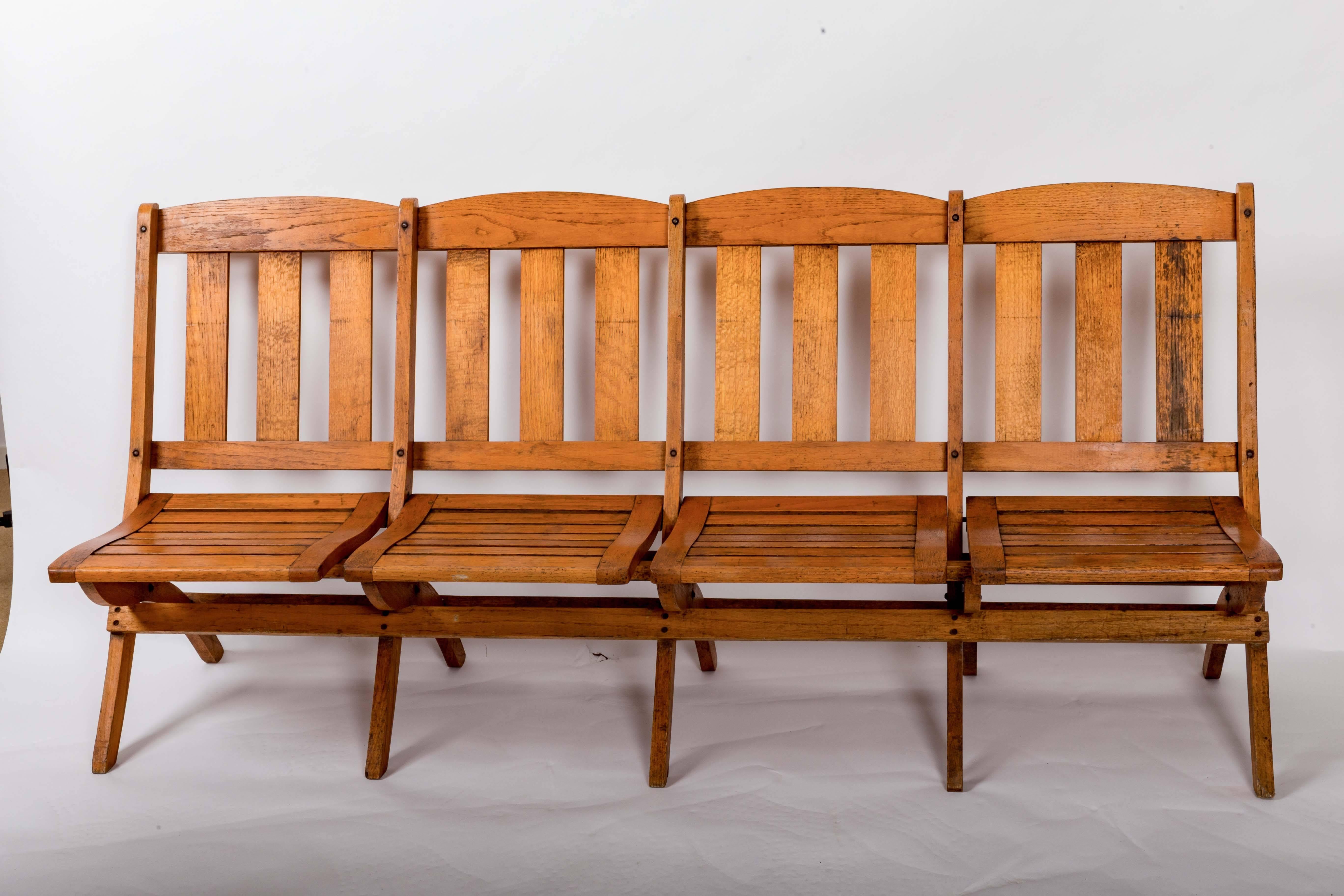 Folding oak railway car bench, slatted back and seat. Each seat folds back individually. Solid construction and deep comfortable seat.