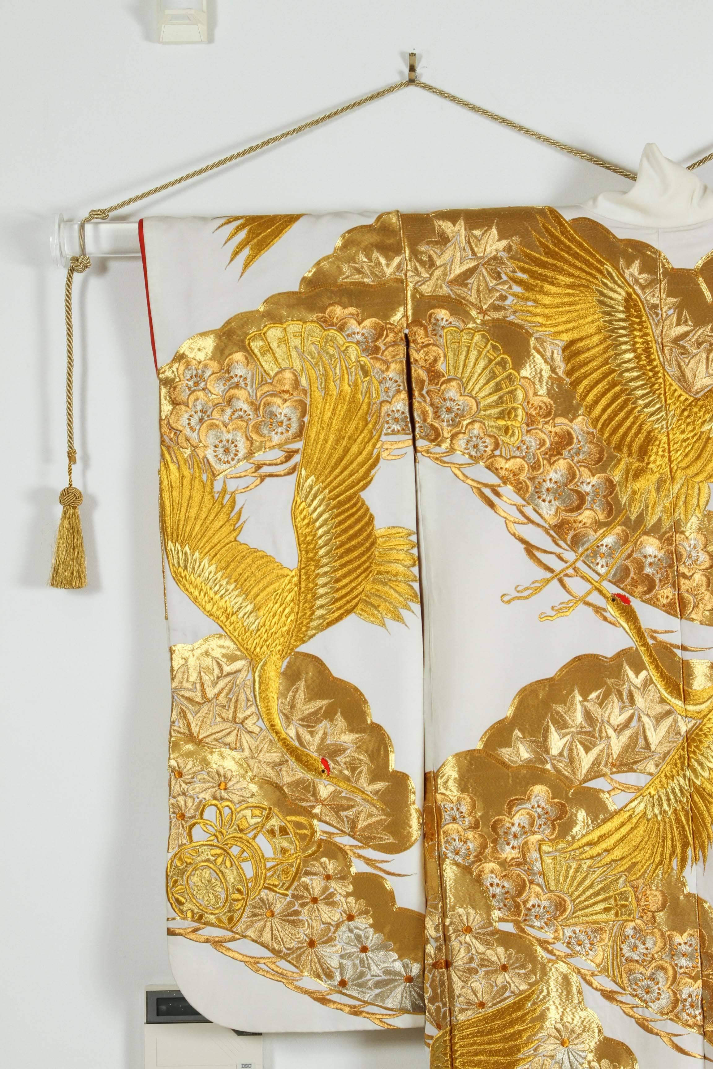 A vintage Mid-Century collectable Japanese ceremonial kimono.
On display Lucite barre and gold cords.
One of a kind hand crafted fabulous Museum quality ceremonial kimono in pure white silk with intricate detailed gold hand-embroidery of cranes