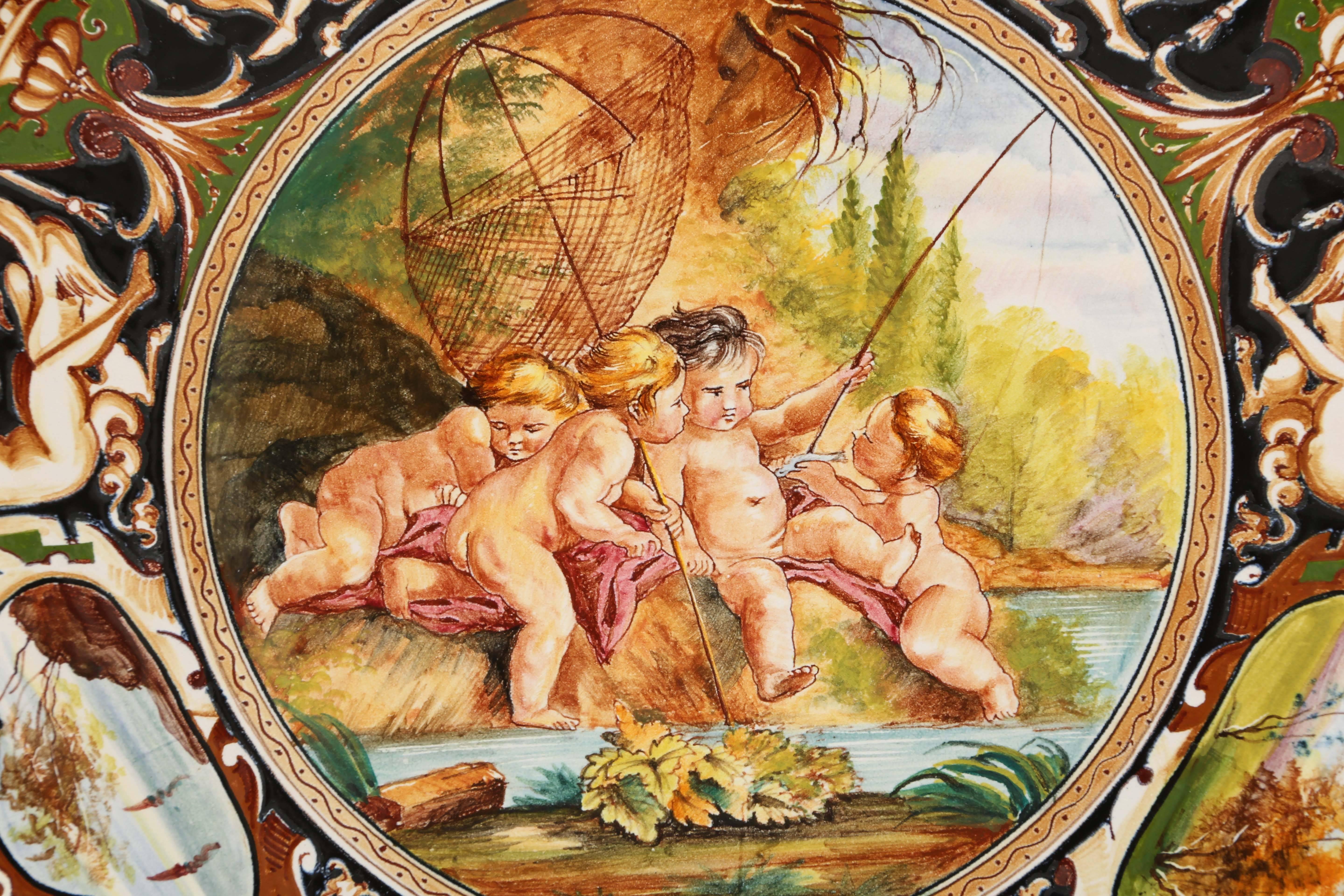 Delightful Italian majolica putti charger signed Boucher, Italy on underneath.