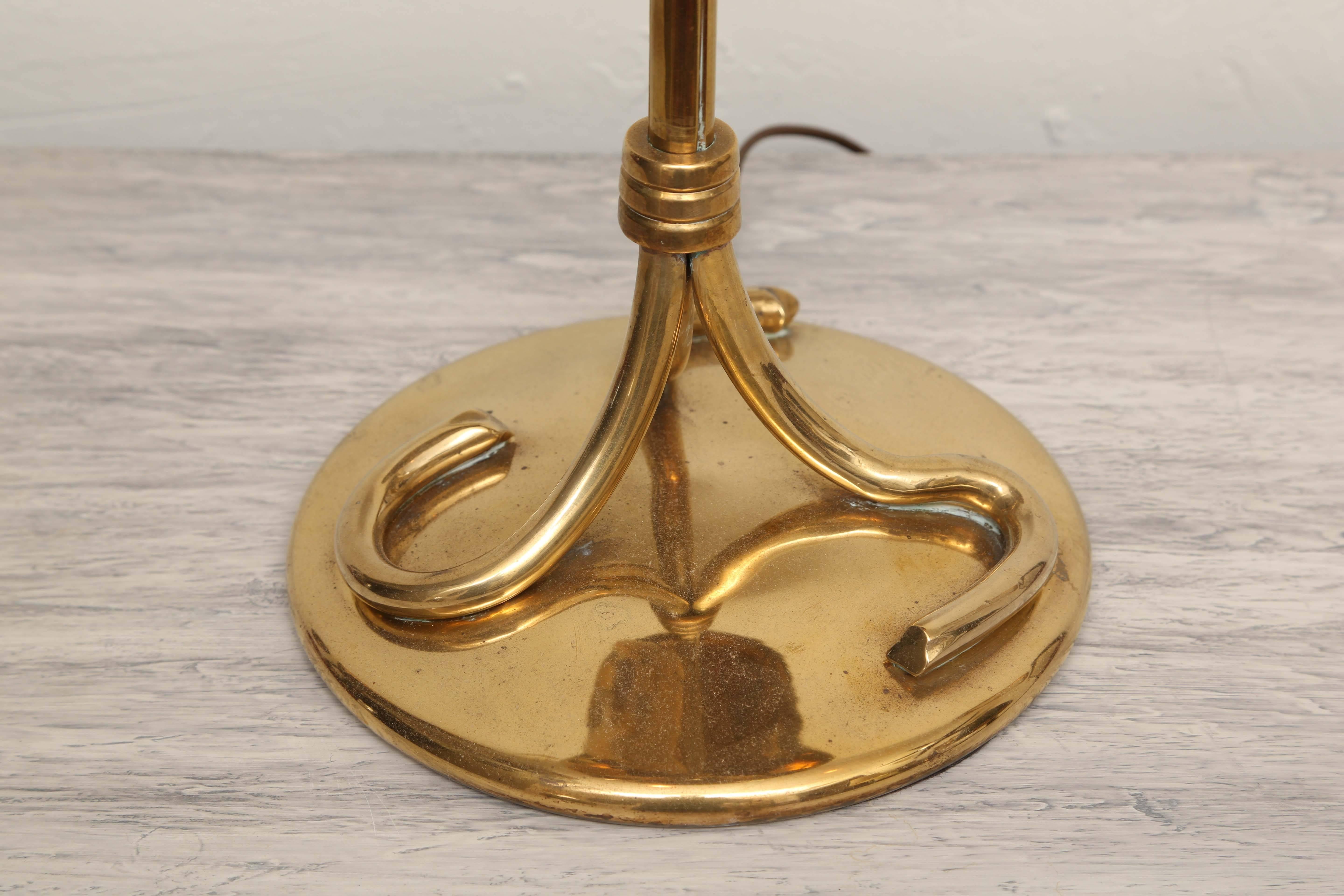 Very striking and unusual brass table lamp with brass leaves supporting a black tole shade and an outstanding finial.