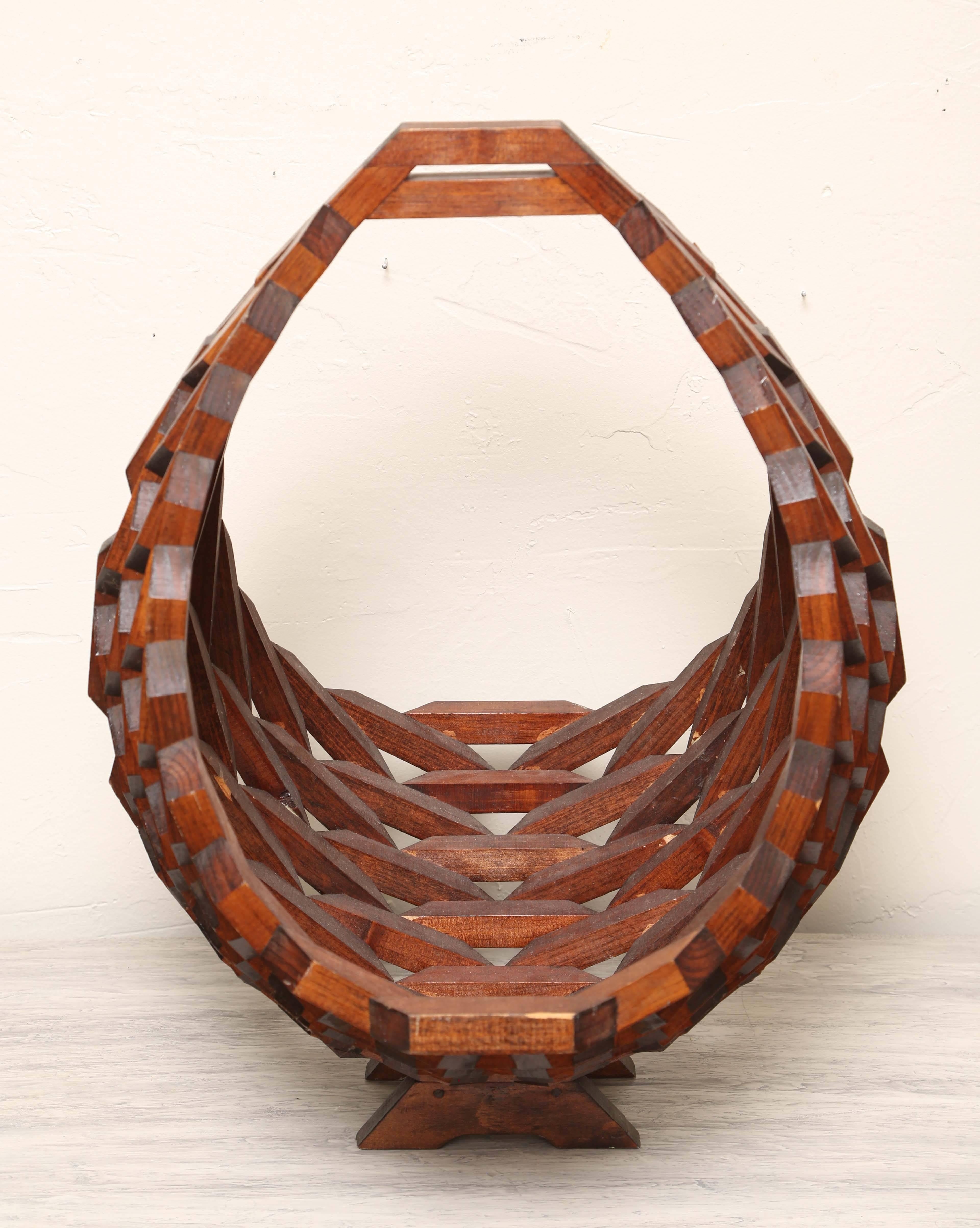 A very unusual and interesting handmade wooden magazine holder in the shape of a basket.