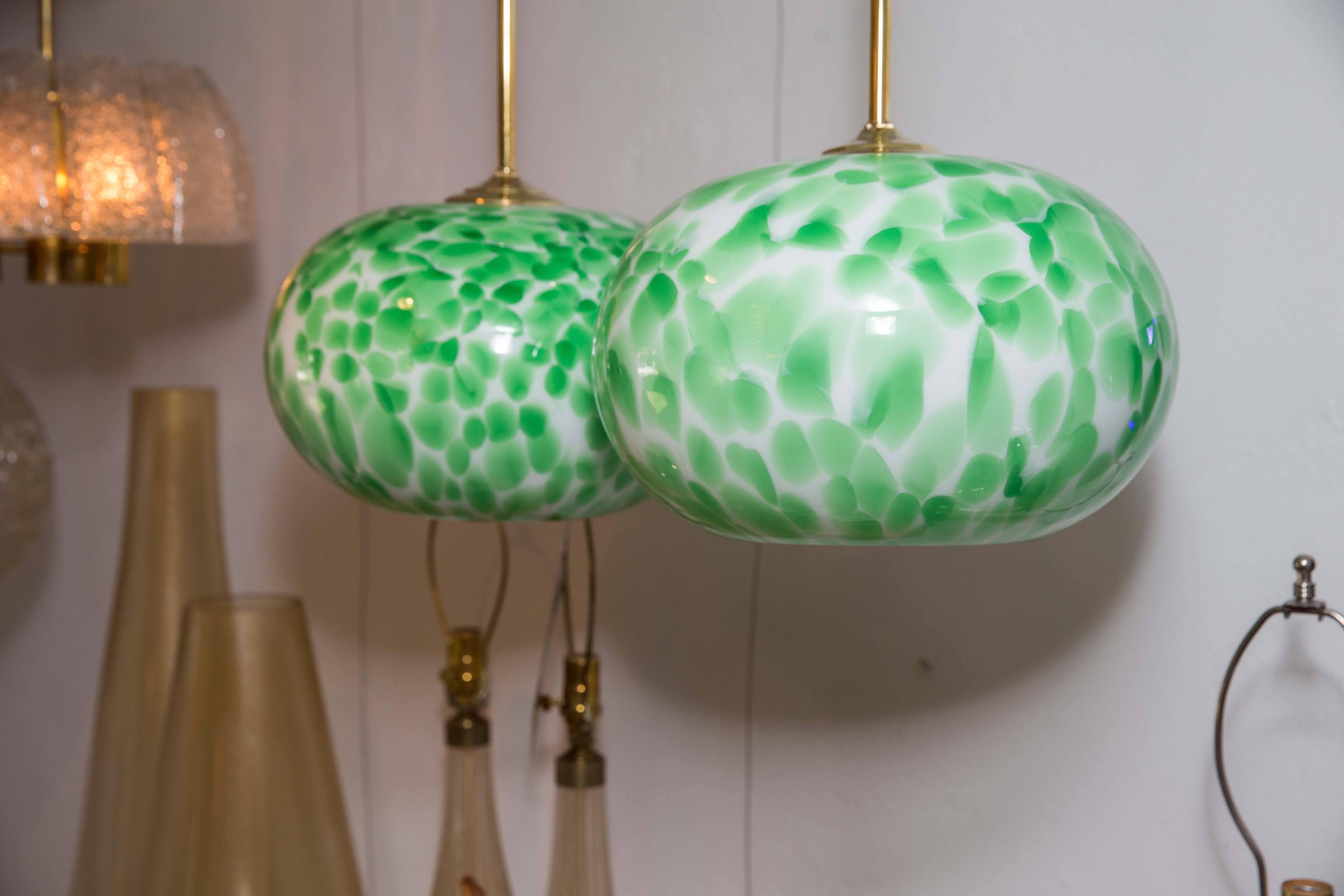 Murano green and white opaque globe pendant light fixture with brass detail.