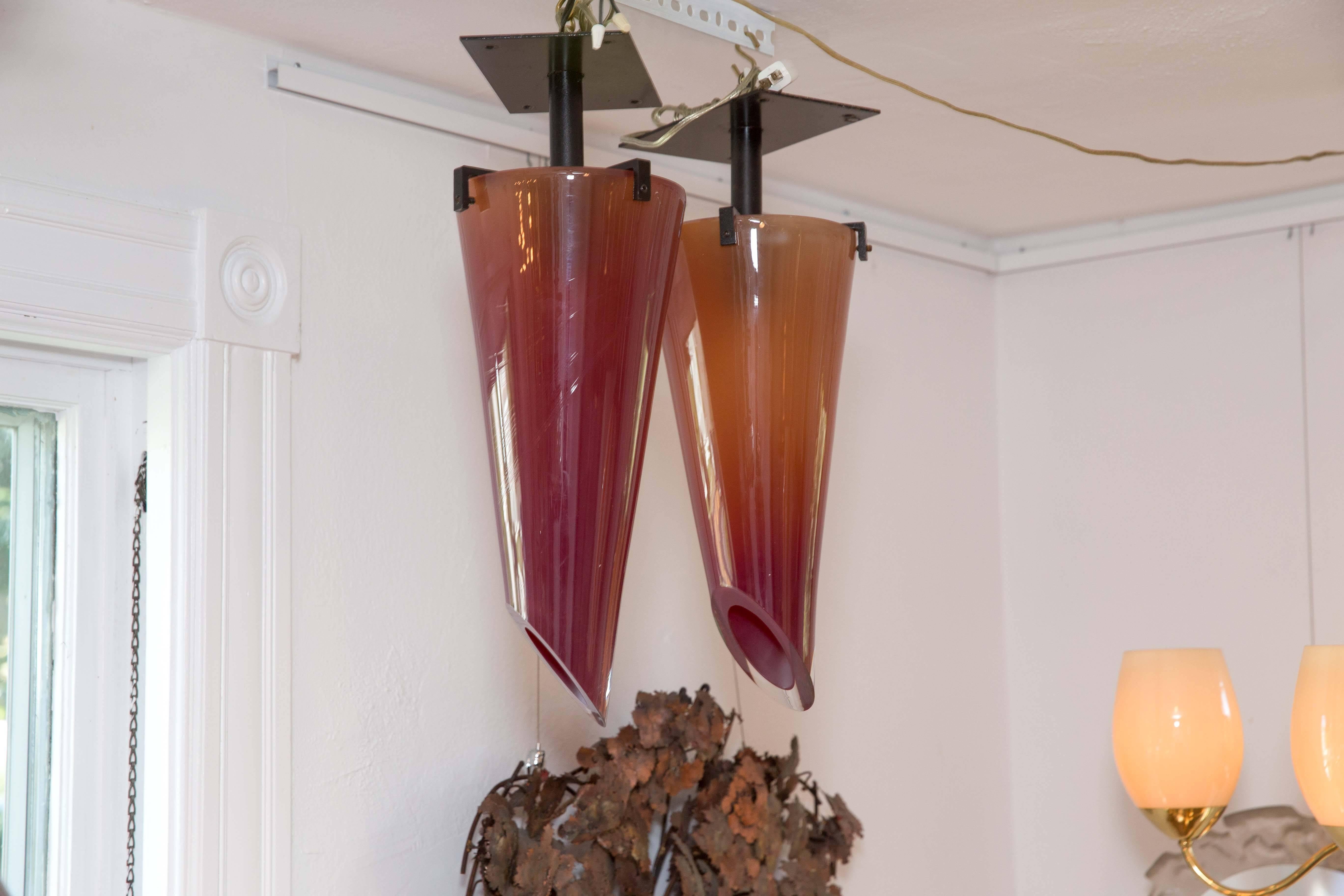 Pair of amber glass and metal chandeliers, by Seguso.