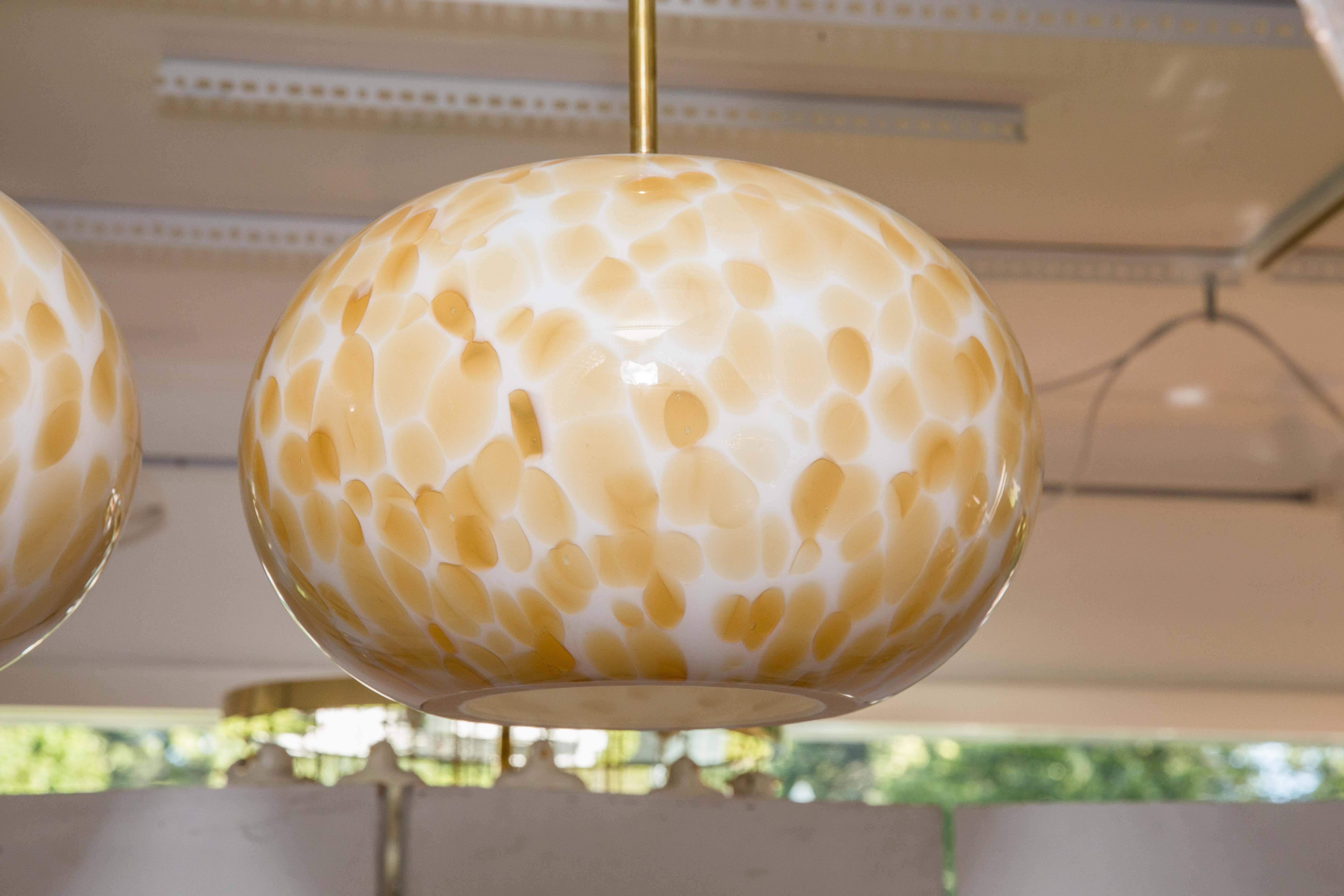 Murano gold and white opaque globe pendant with brass detail.