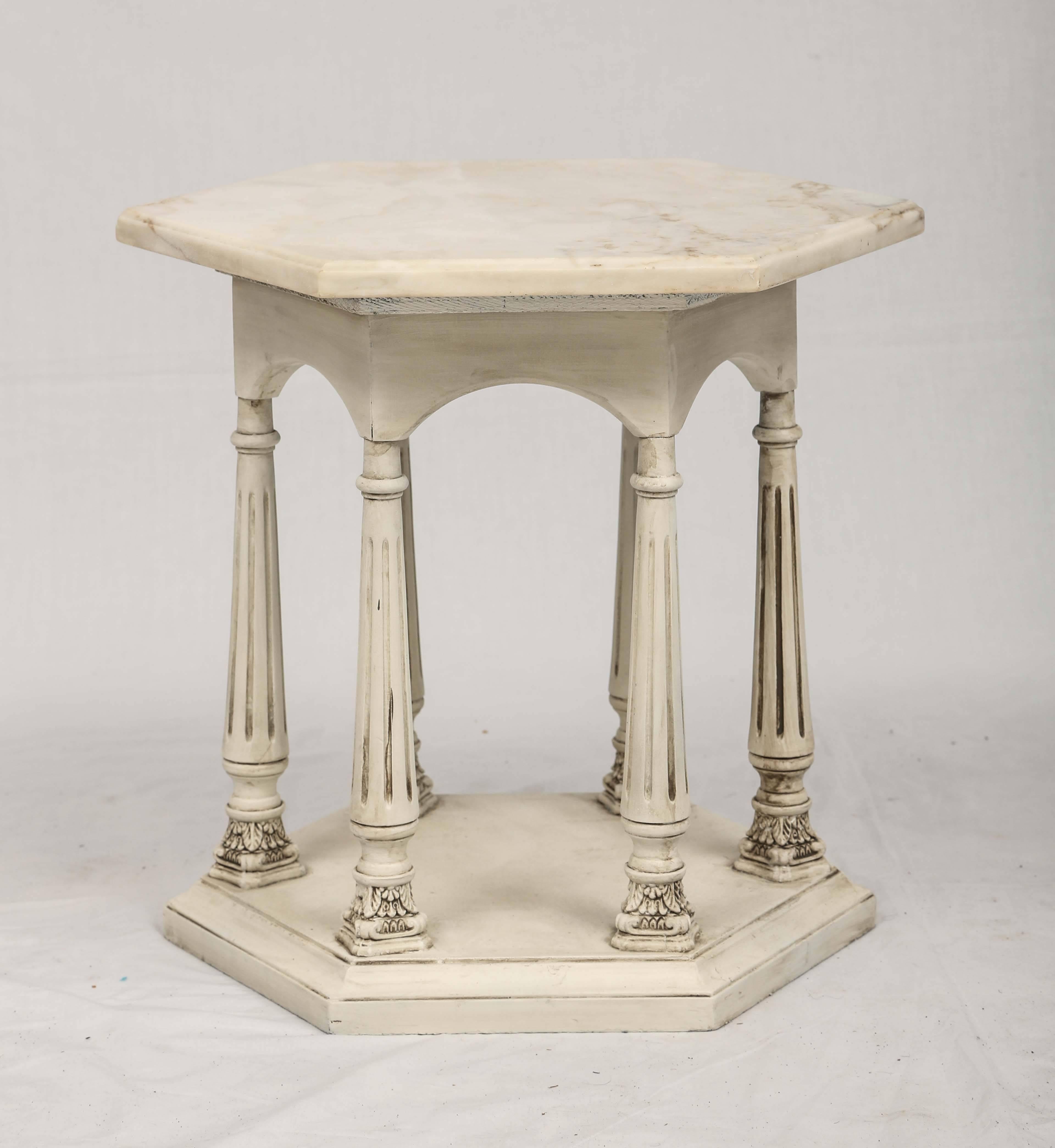 Side table, having an octagonal top of white marble, on carved wood, painted, base, shaped as a colonnade of fluted columns, on molded, conforming base.

Stock ID: D9401