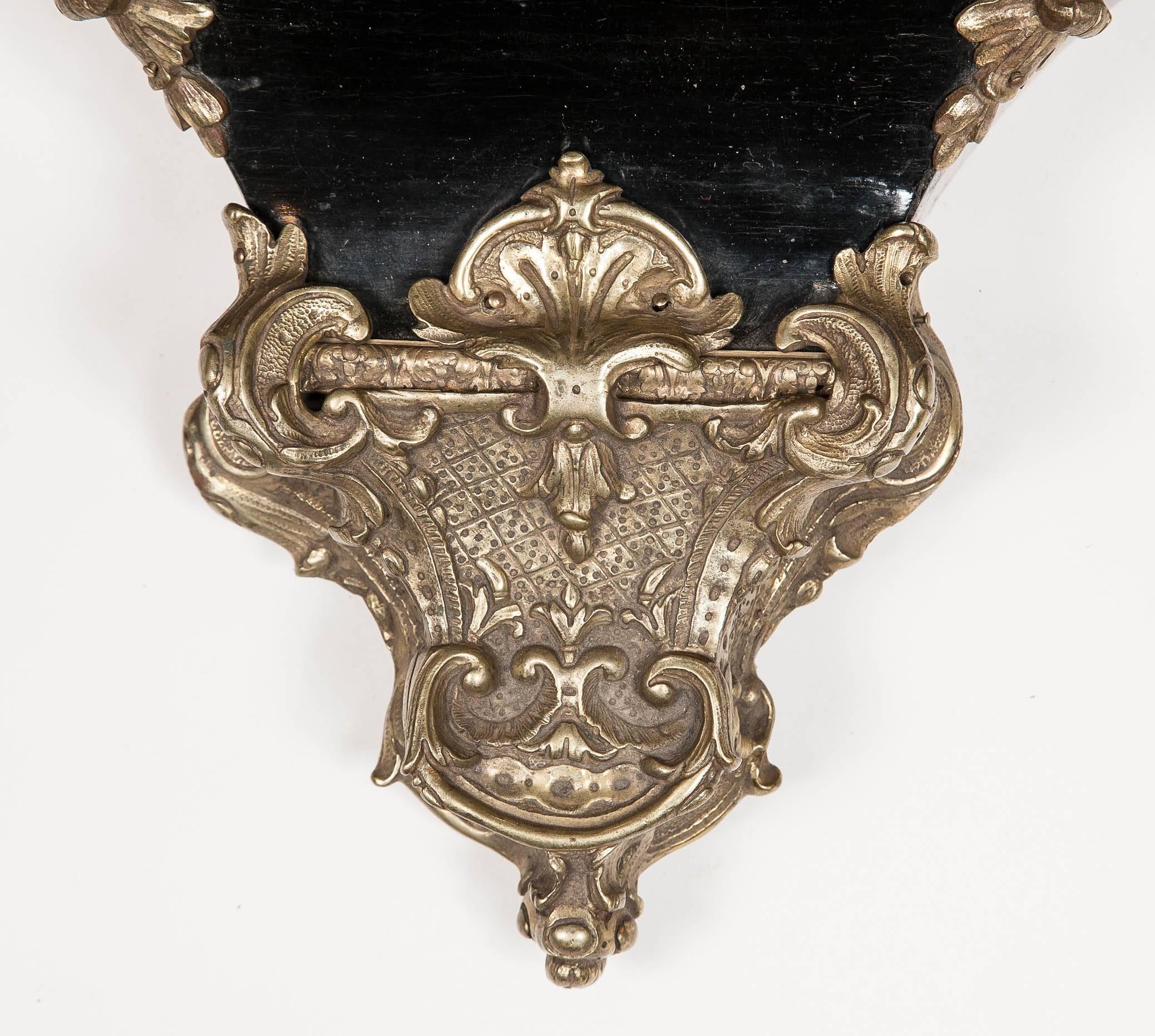 A Napoleon III ebonized French Louis XV style wall bracket with brass mounts.