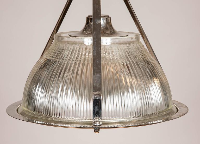 1960s nickel plated hanging lights formerly used to light aircraft hangers made by Holophane.

Rewired for domestic electricity.

We have more of these lights available, please contact us if multiples are needed.

Holophane is a manufacturer