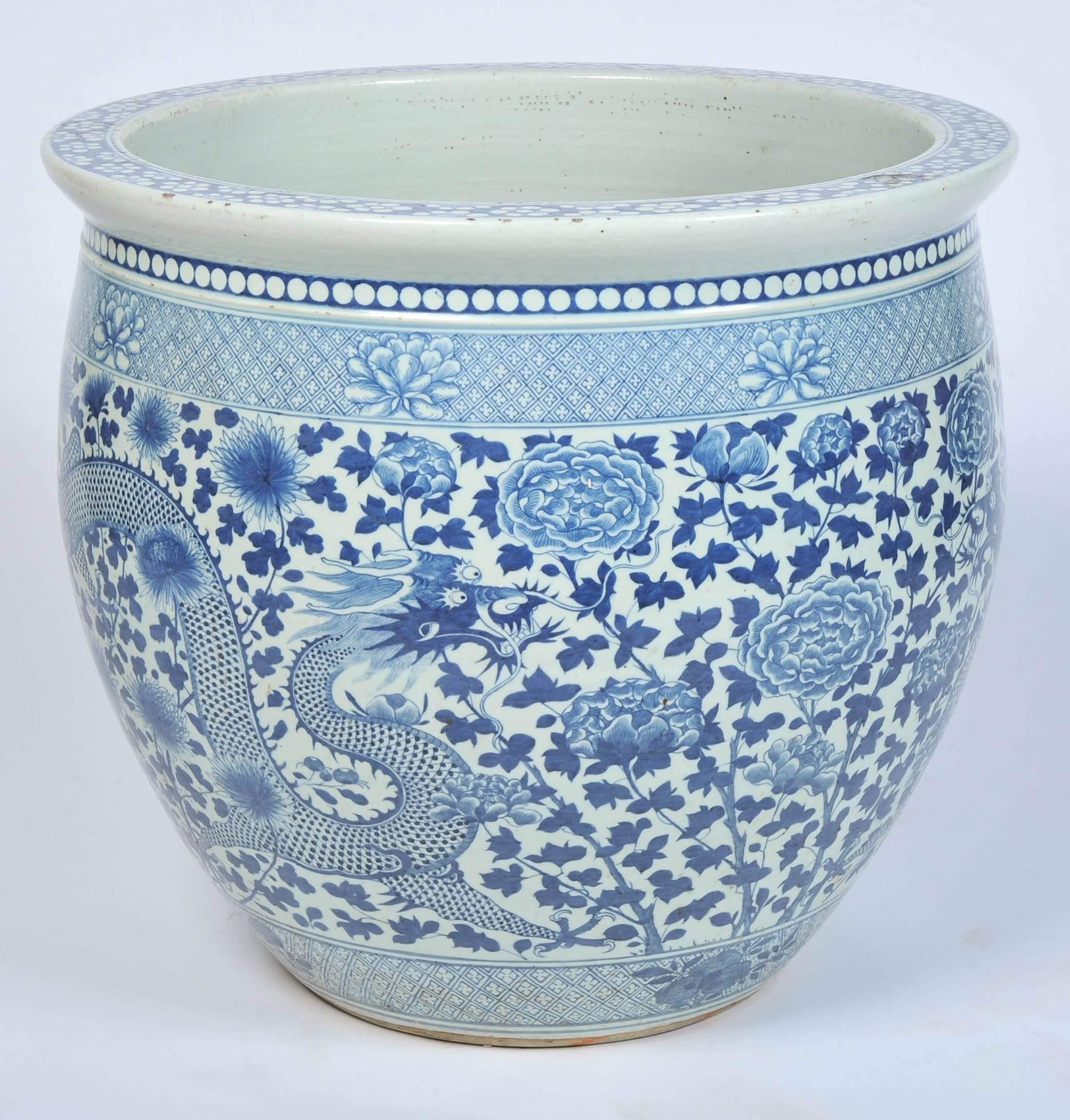 A large and impressive pair of 19th century Chinese blue and white jardinieres each depicting mythical dragons and motifs.