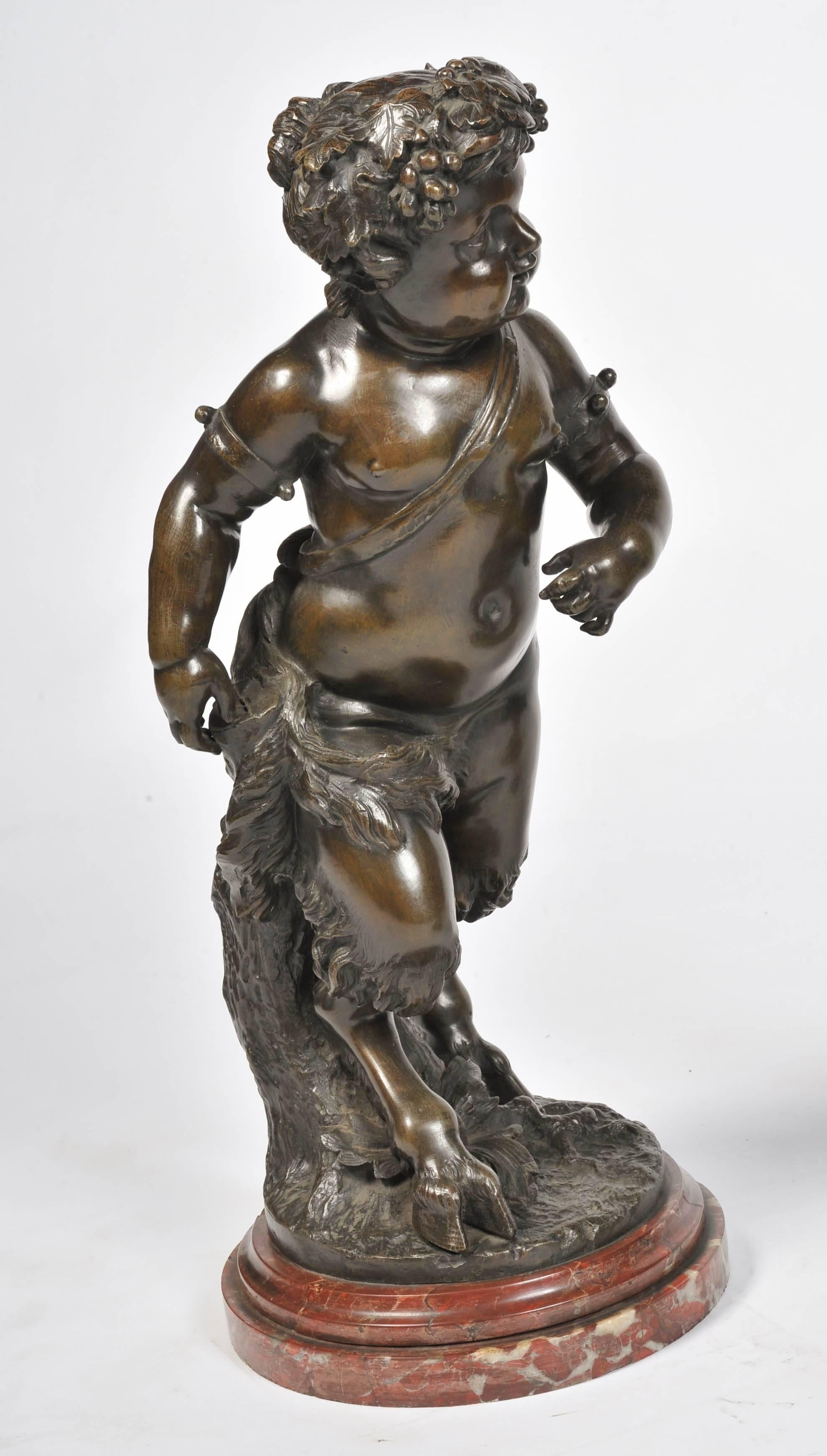 An impressive large pair of French patinated bronze putti, mounted on rouge marble bases.