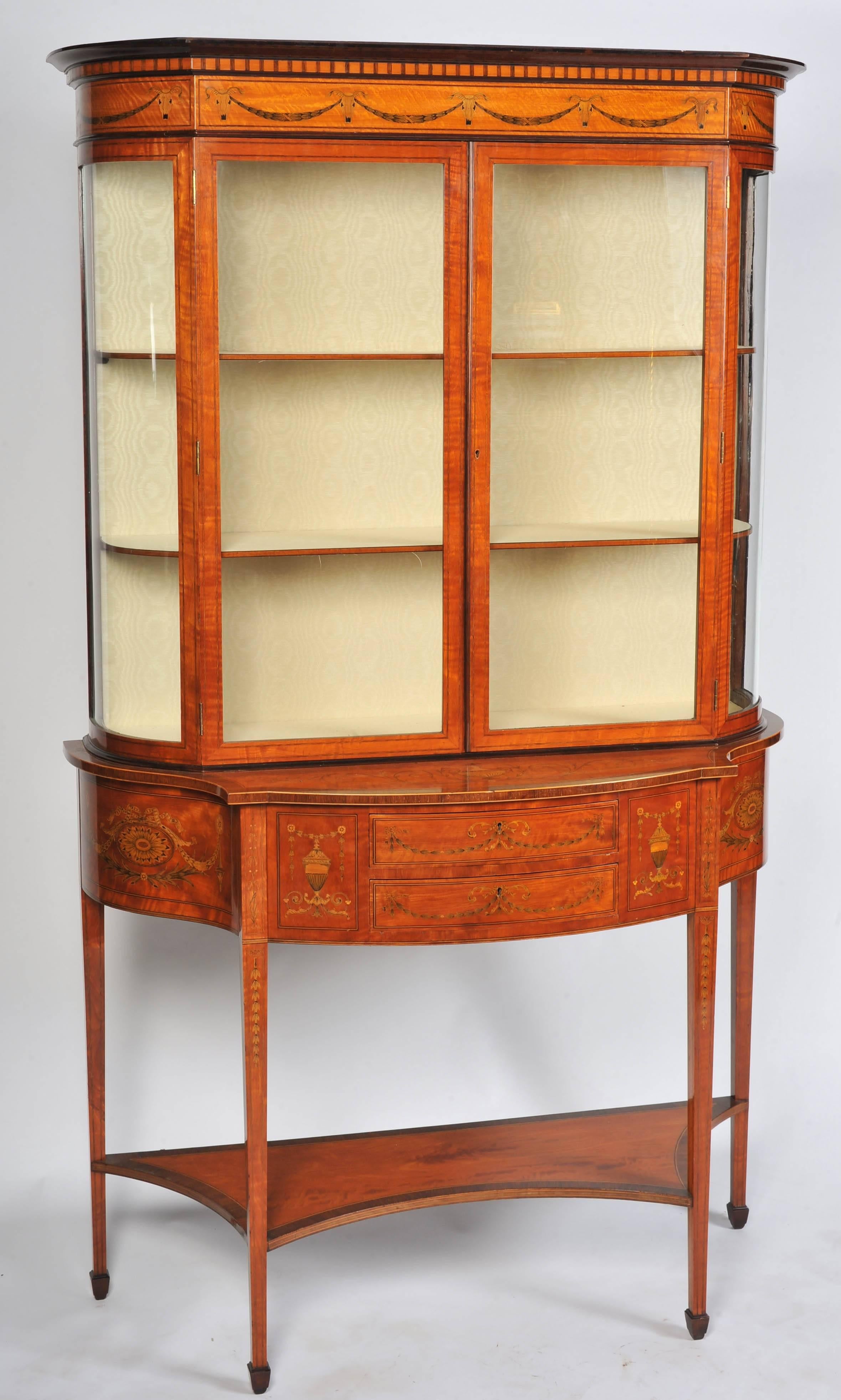 A fine quality English Edwardian satinwood, Sheraton Revival display cabinet, by Edwards & Roberts, London. (1845-1900) having classical inlaid decoration, two frieze drawers, raised on square tapering legs.