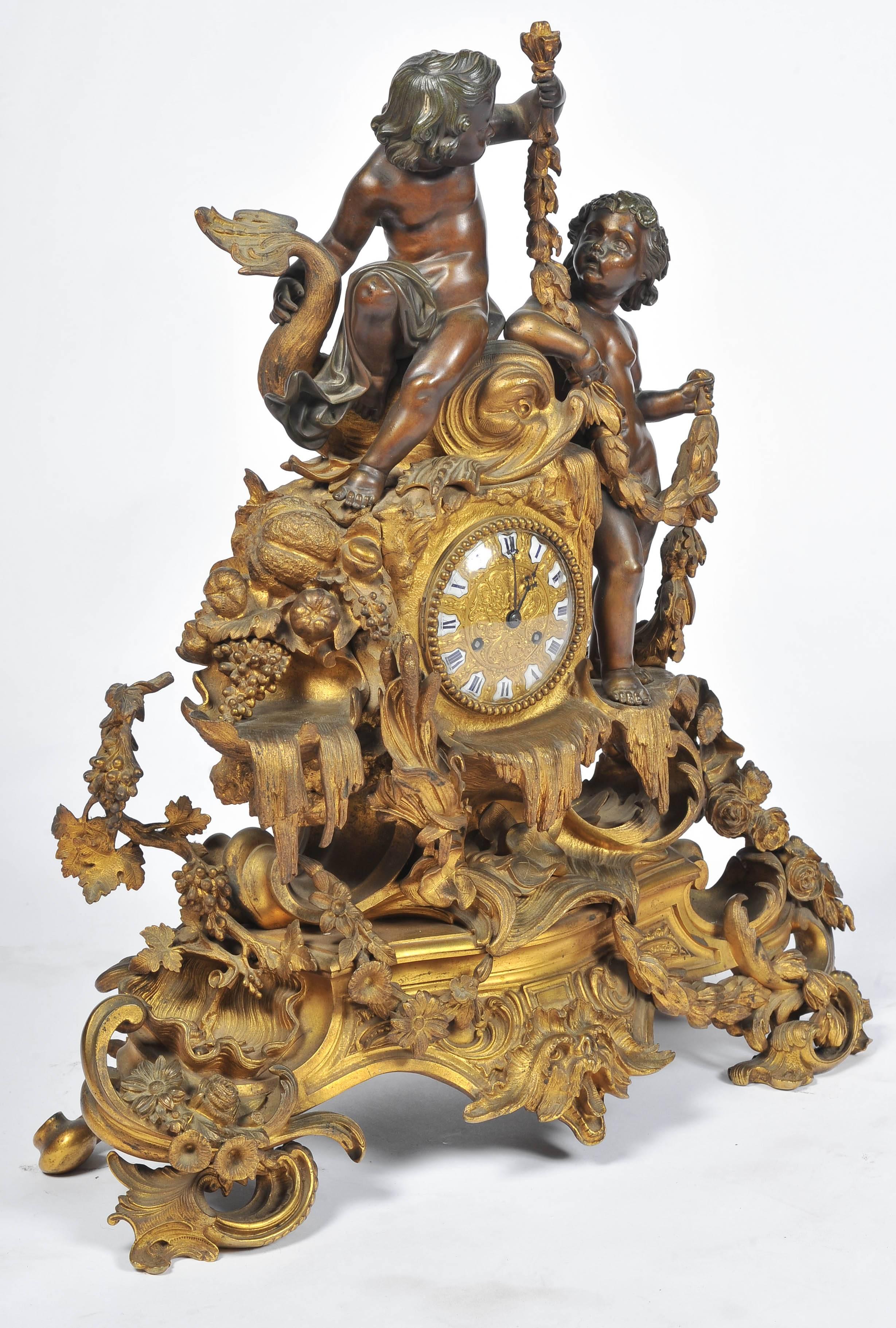 A very impressive 19th century French gilded ormolu clock. Having two putti with swags, drapes and foliage around the eight day chiming clock.