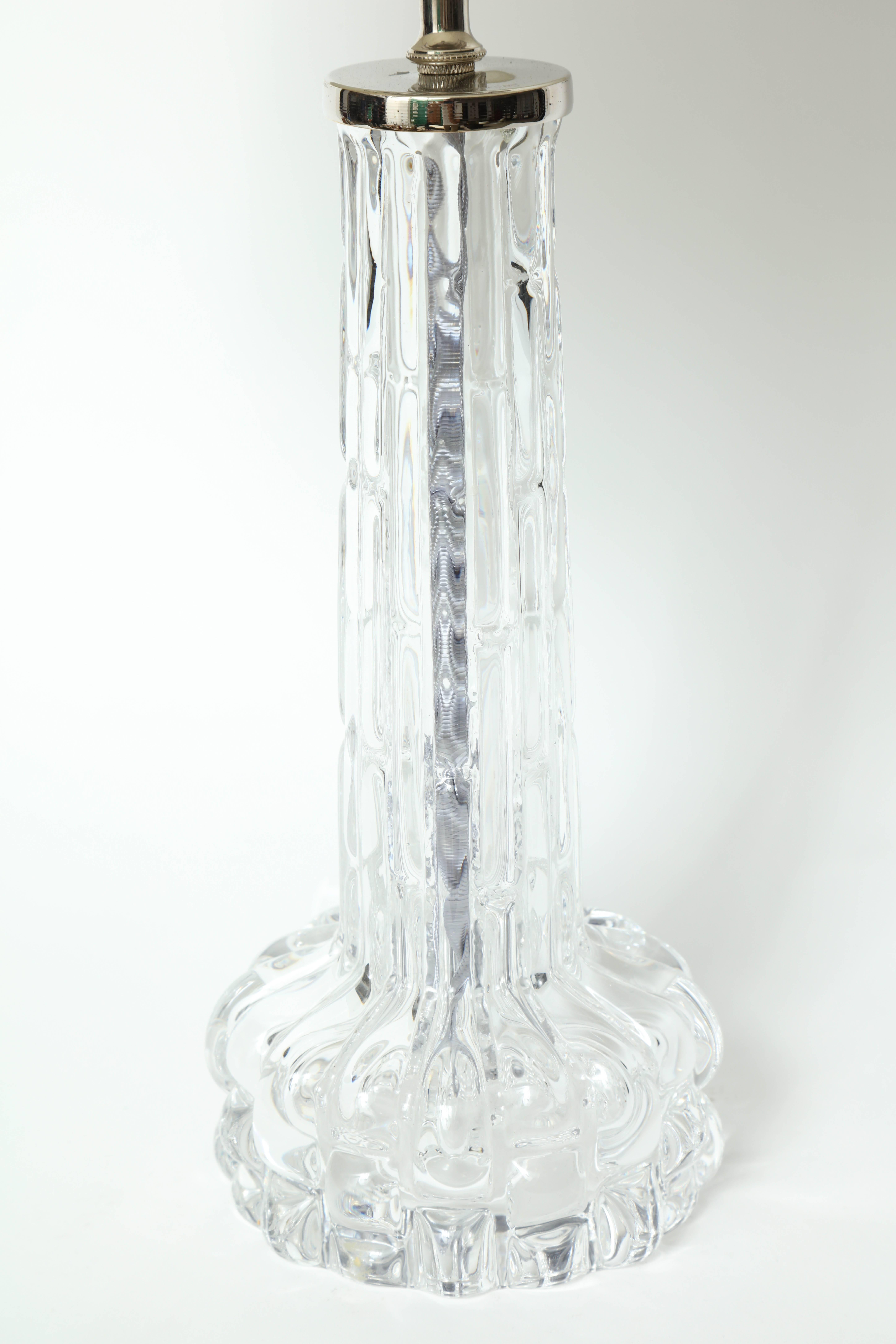 Pair of thick crystal lamps with an embossed croco texture. Lamps have a polished nickel cap, stamped. Orrefors featuring new sockets and silver silk twist cords. Lamps use standard bulbs, 100W max. Shades not included.