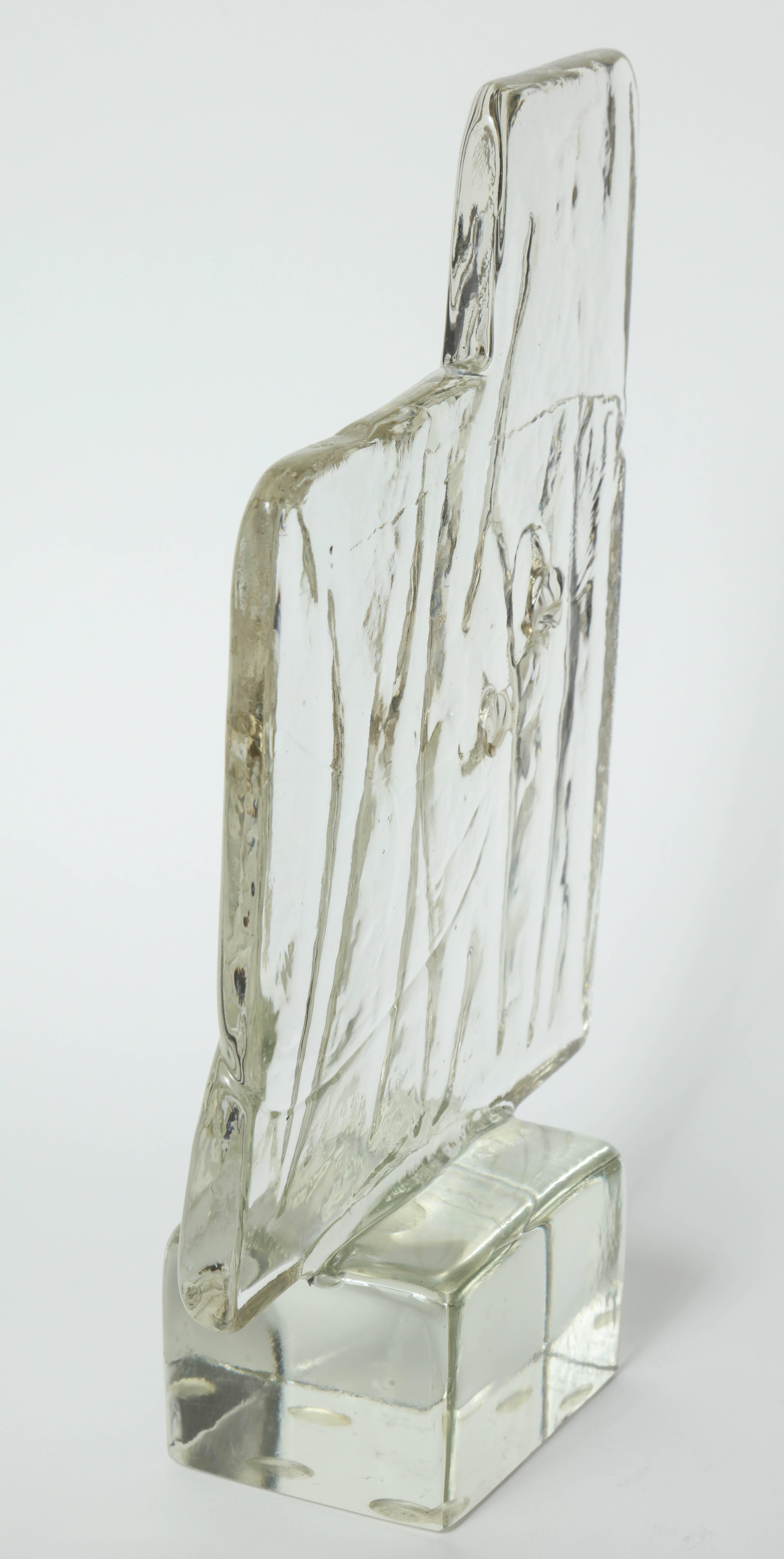 Modernist clear textured abstract Murano glass blade sculpture with two open spaces resting on a solid glass base. Signed.
