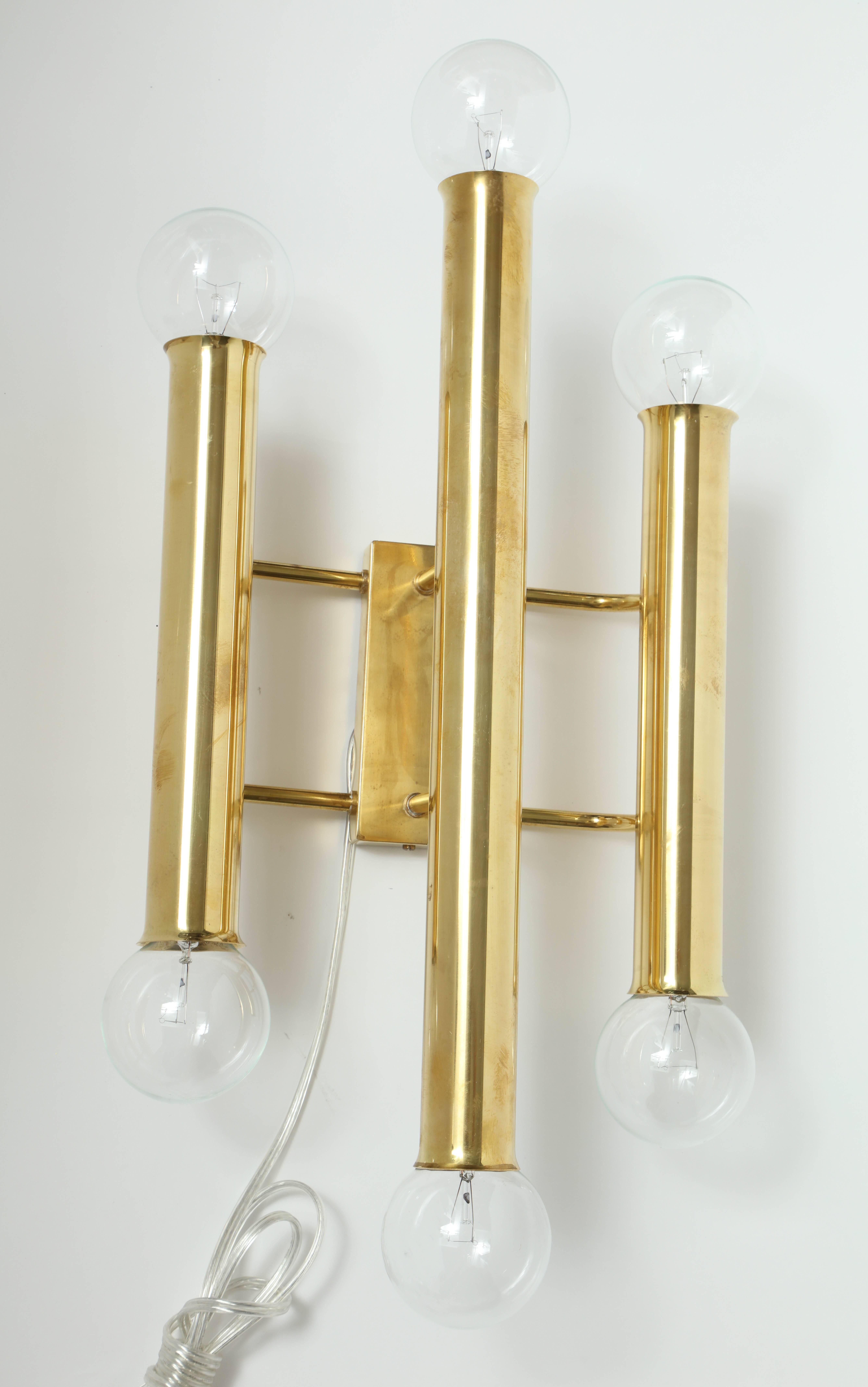 Pair of large scale Minimalist solid brass sconces with six light sources. Rewired for use in the USA. The elegant simple lines of these sconces make them useful in various interior designs.