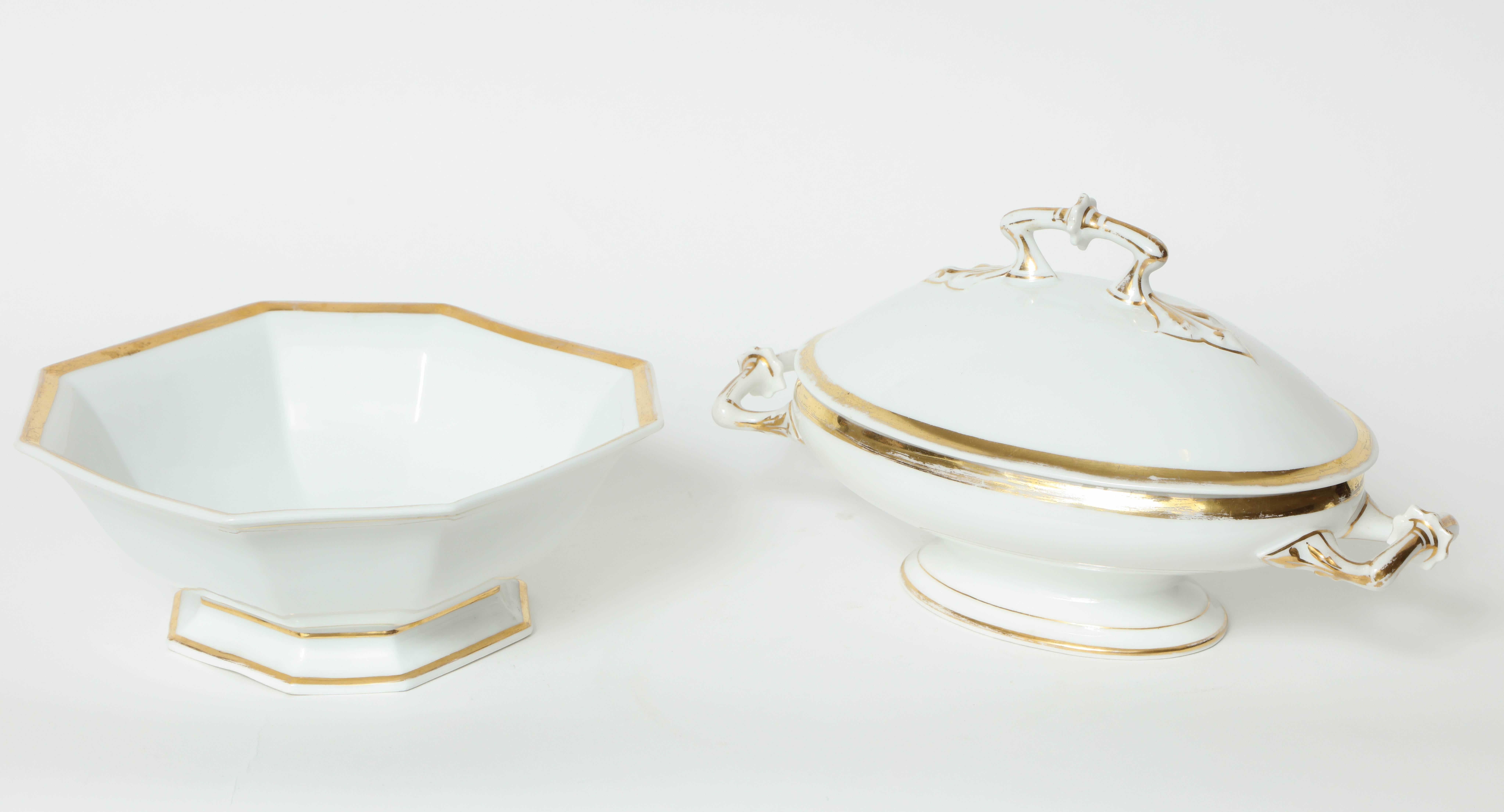 Set of two porcelain serving dishes with gilt accents. Set includes an octagonal dish with a flared base while the other is oval with lid.

Octagonal measures 9 3/8