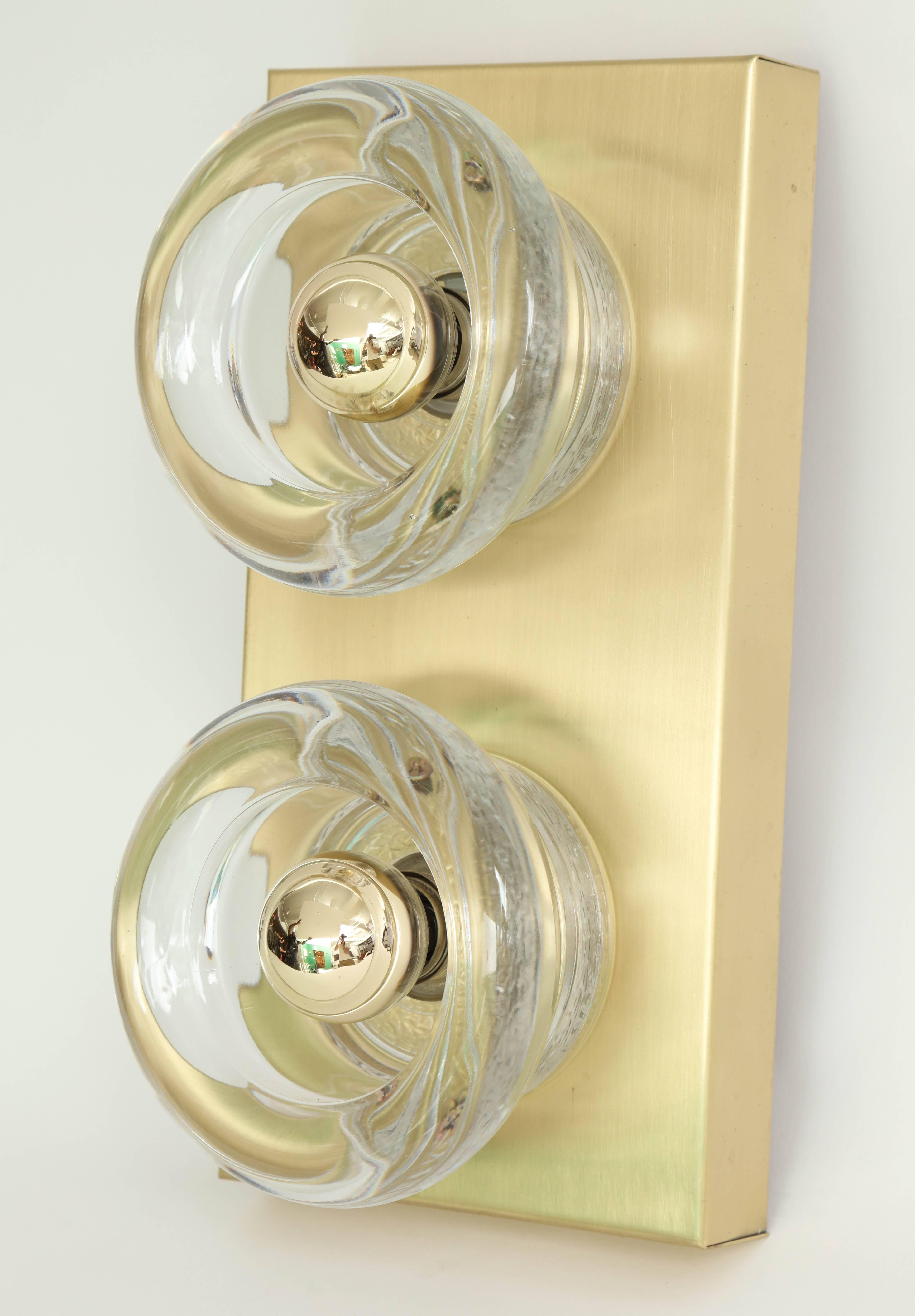 Pair of Mid-Century Italian Classic sconces composed of brushed brass back plates and two molded glass elements by Gaetano Sciolari. Rewired for use in the USA.
