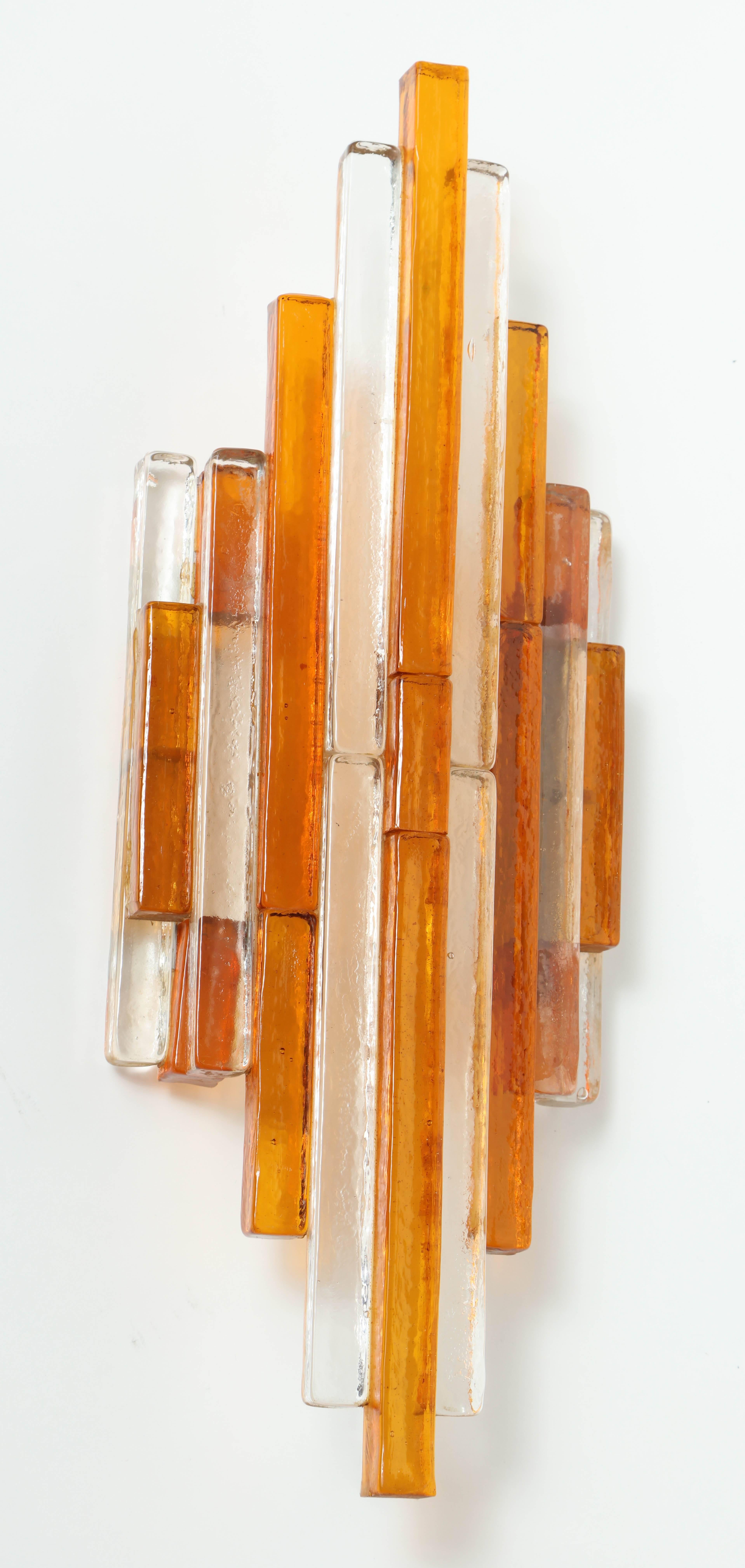 Pair of Italian Mid-Century sconces composed of stacked amber and clear glass rectangular bars. Sconces have steel backs and have been rewired for use in the USA.