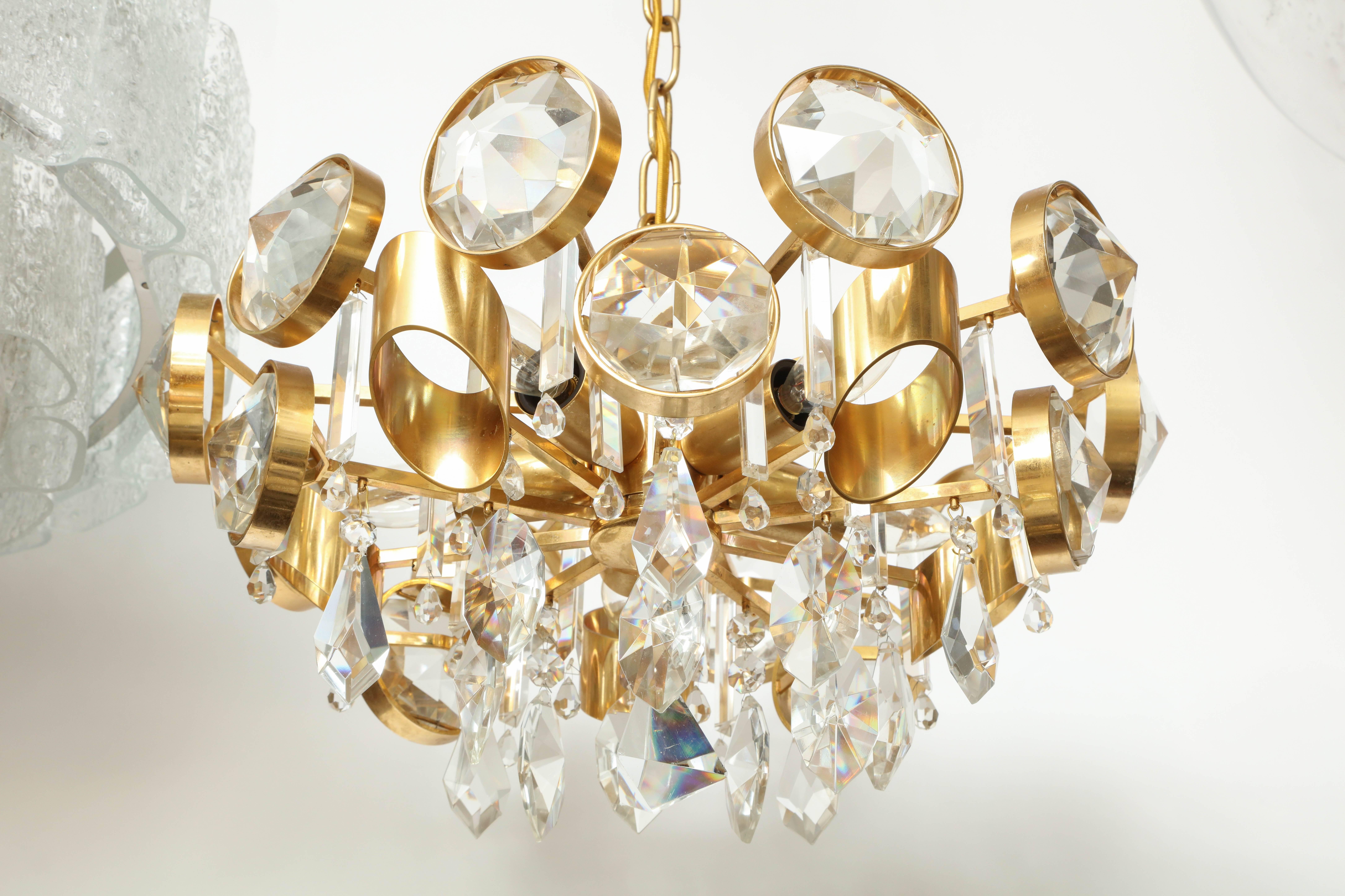Hollywood Regency eye-catching chandelier with large round faceted Austrian crystals housed in a gilt washed frame featuring faceted cascading crystal drops in the center. Rewired for use in the USA, using five chandelier type bulbs.