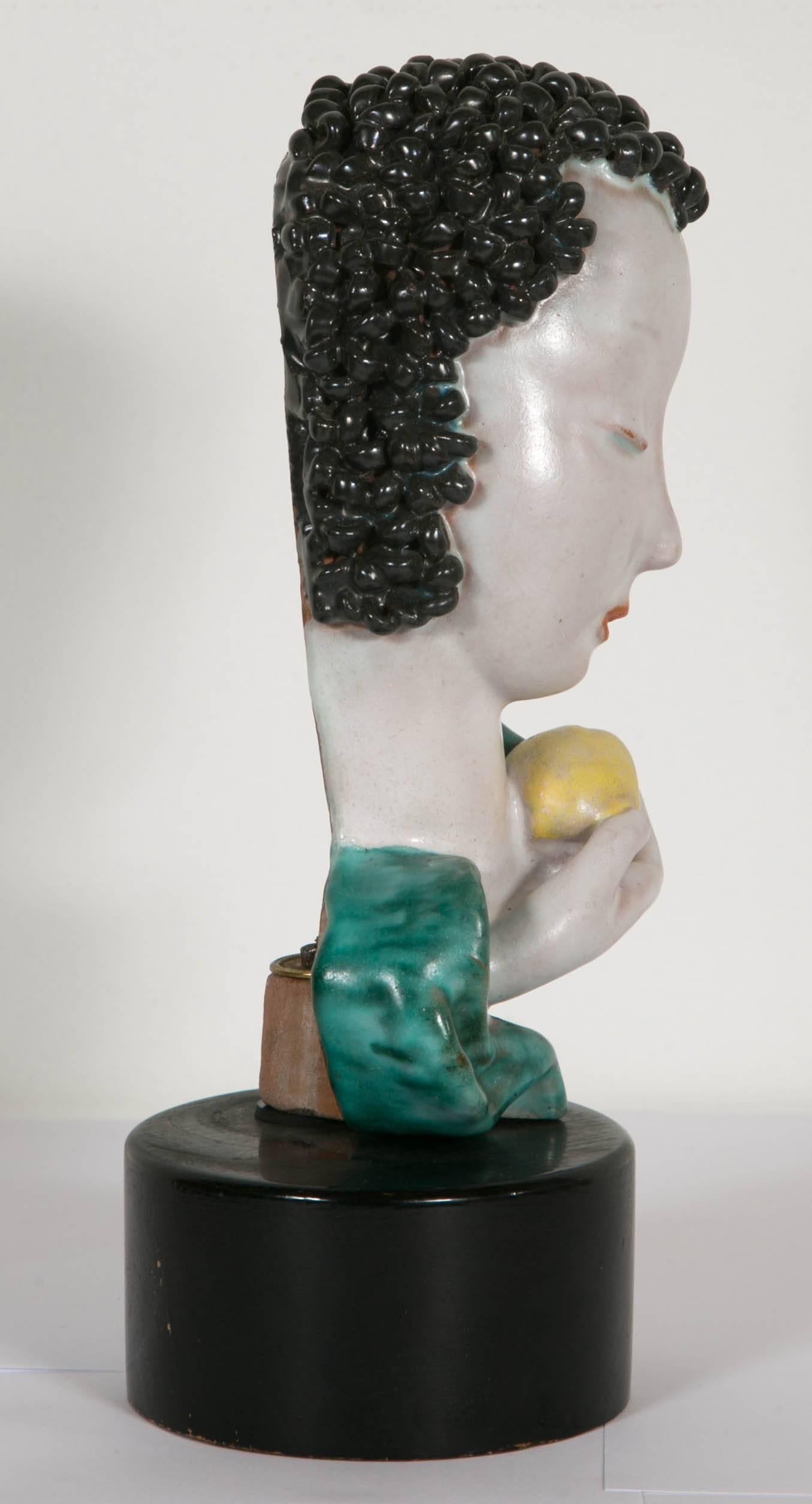 Eve with an apple made in ceramic by the famous Austrian Goldscheider workshop. On a wooden base. Signed inside, circa 1933.
The little bust is characteristic of the works its designer - Rudolf Knörlein (1902-1988) - realised over the span of nearly